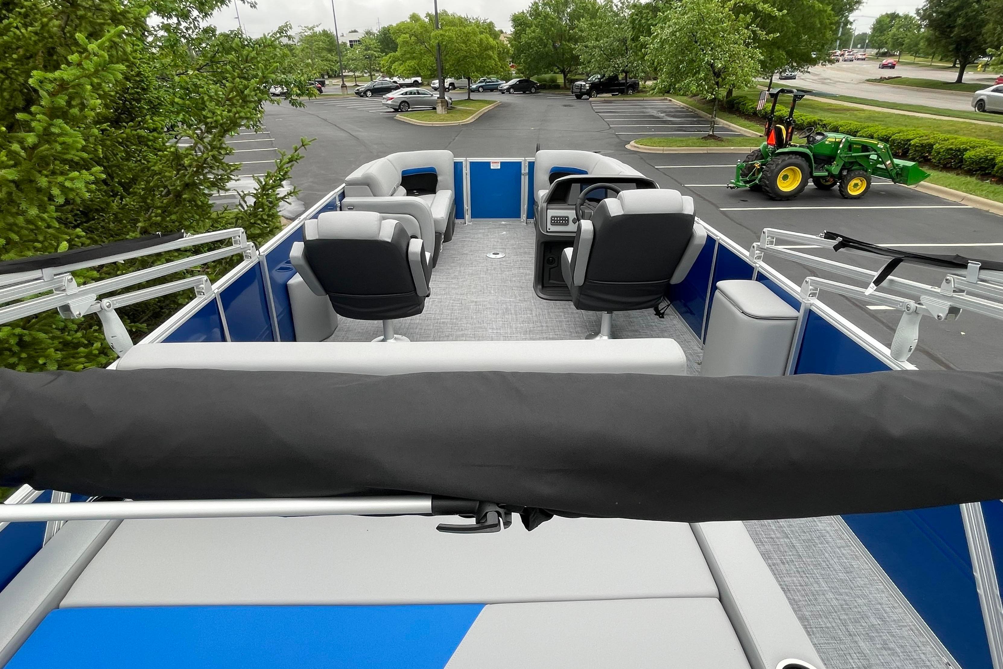 2026 Sun Tracker Party Barge 22 RF DLX pontoon boat interior with seating and steering console.