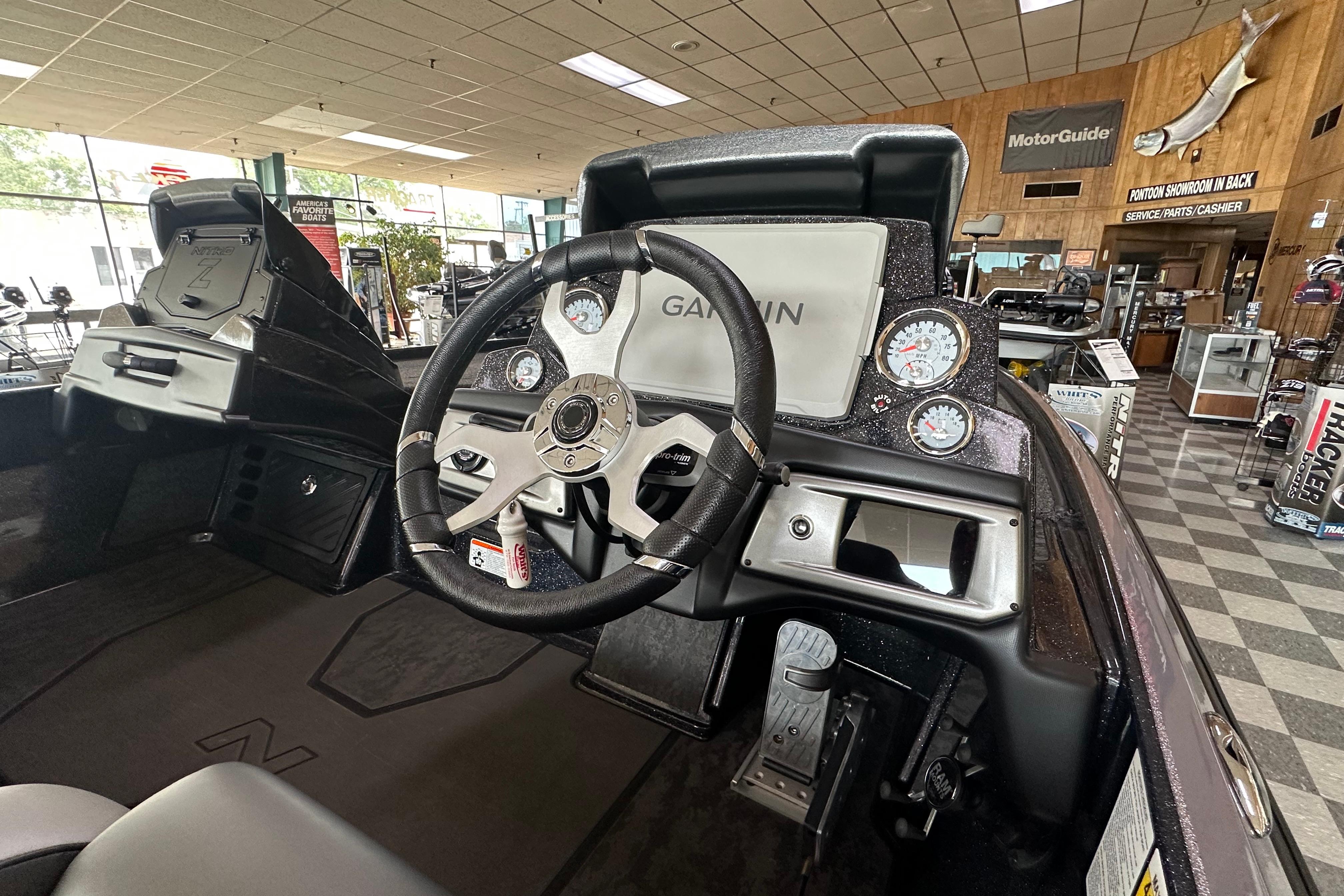 2025 Nitro Z20 XL Pro boat dashboard with Garmin display and gauges in showroom.