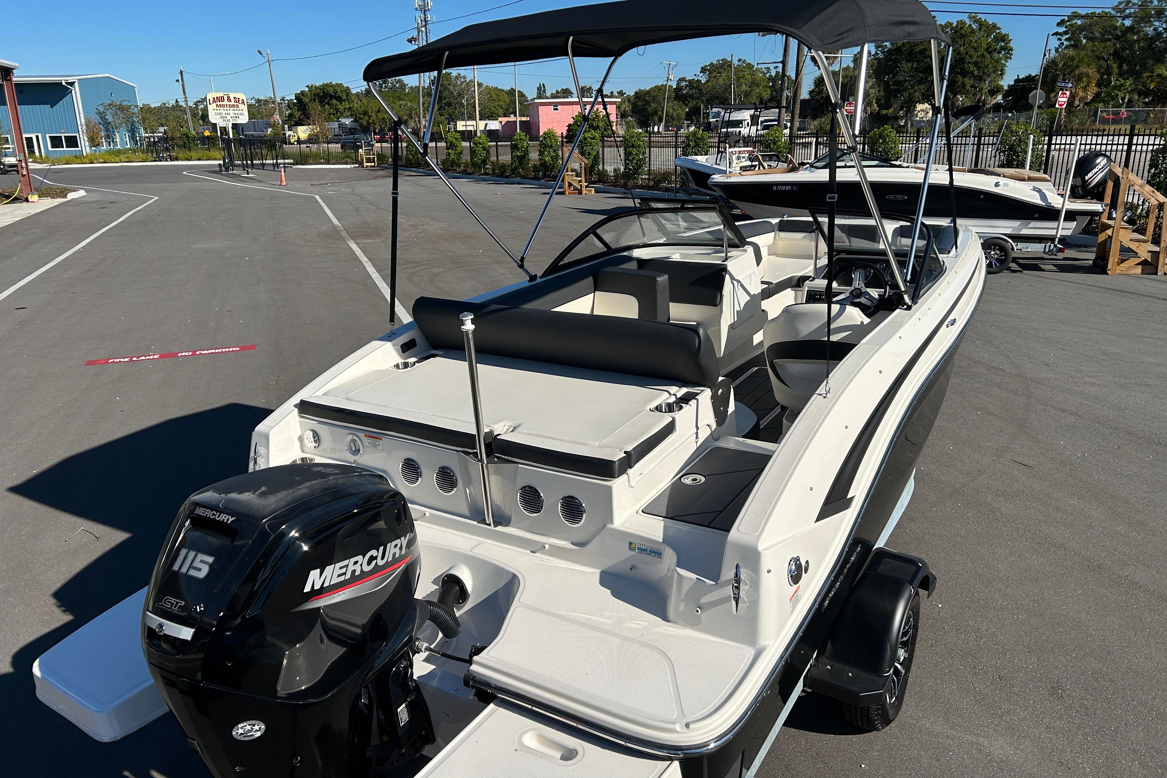2020 Bayliner DX 2000 boat with Mercury 115 engine, parked outdoors under clear sky.