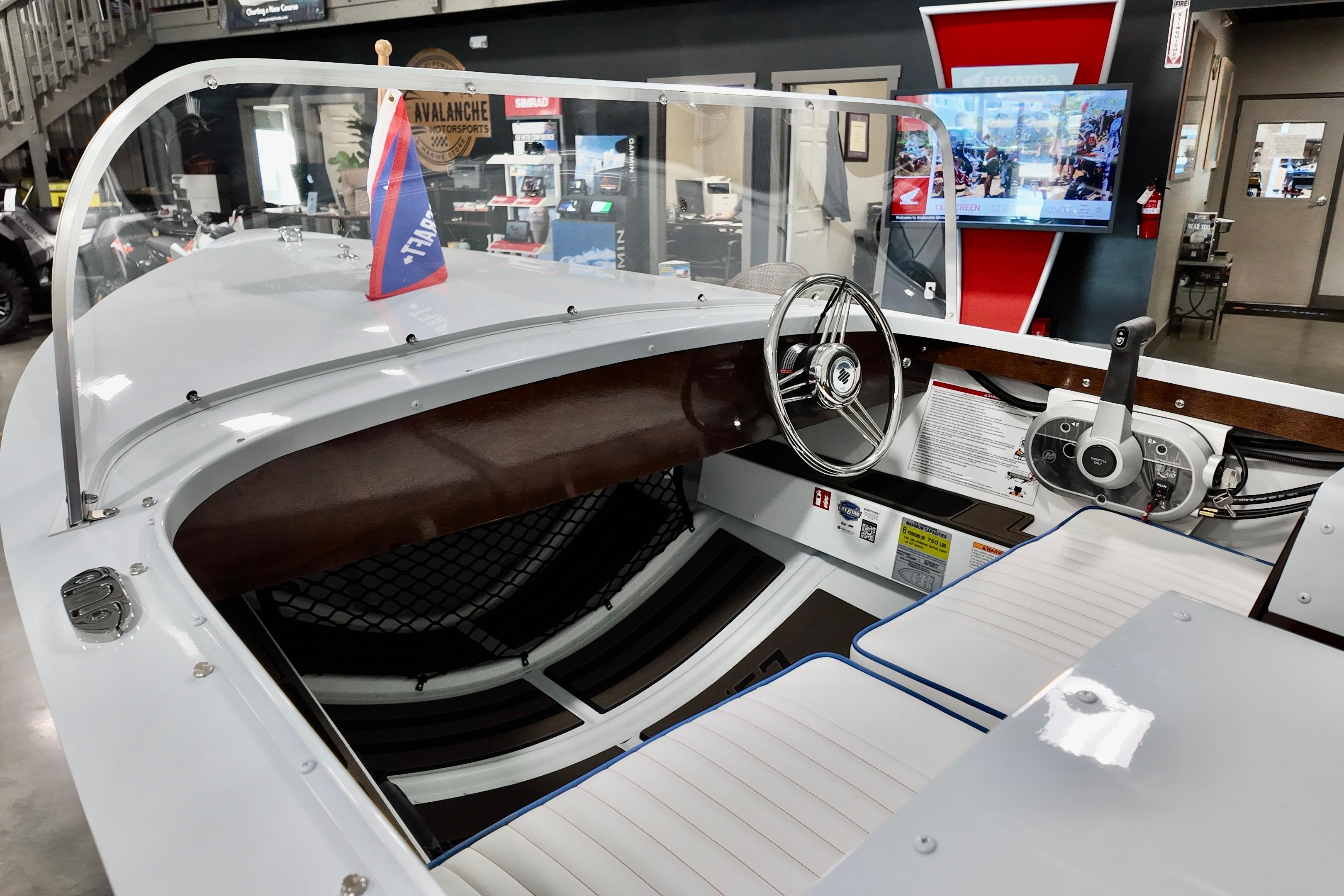 Interior of a 2026 Starcraft 57 Ski Champ boat with steering wheel and controls.