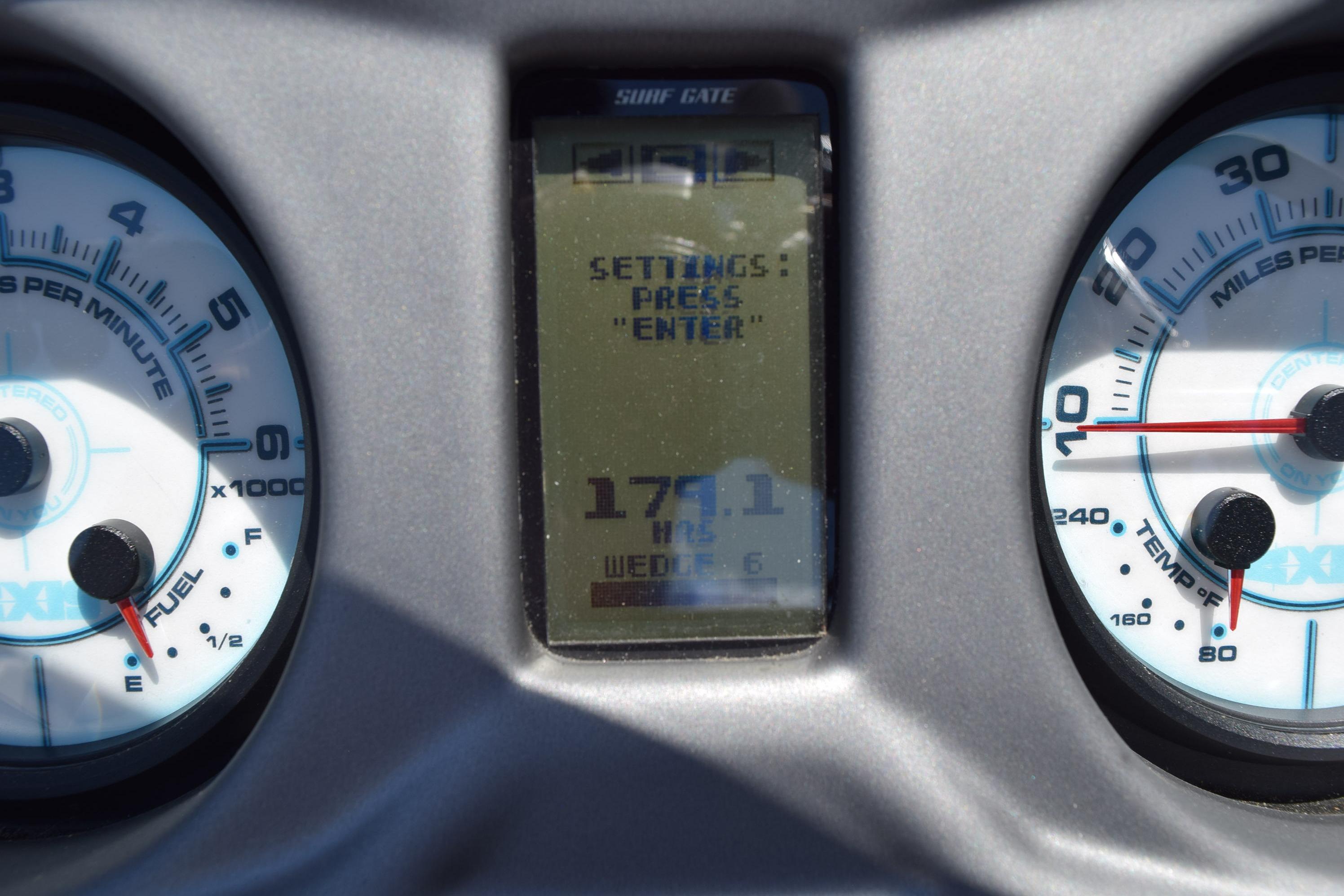 Dashboard of a 2019 Axis A22 boat showing RPM, fuel, and temperature gauges.