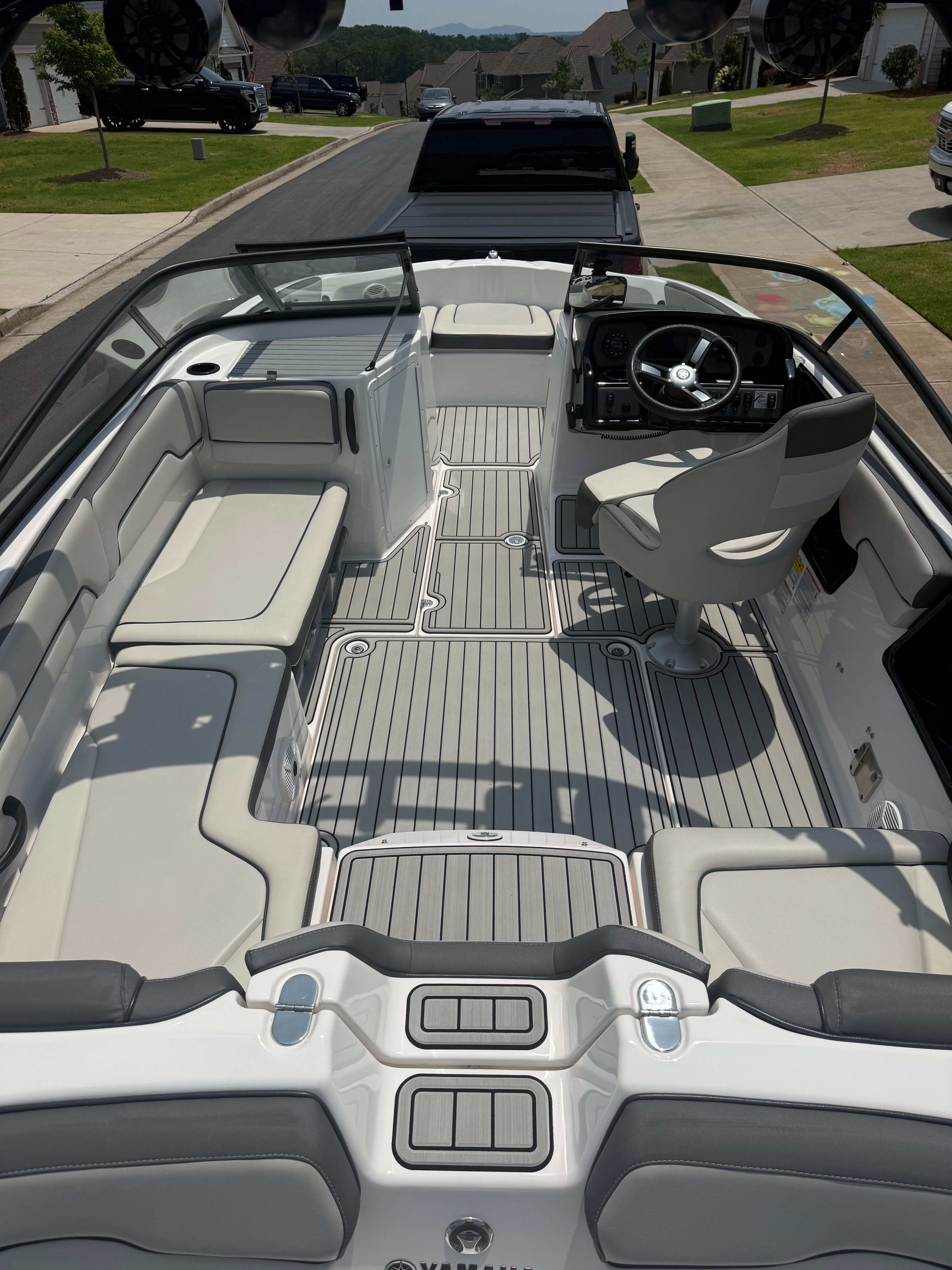 Interior view of a 2023 Yamaha AR190 boat with gray seating and a modern helm.