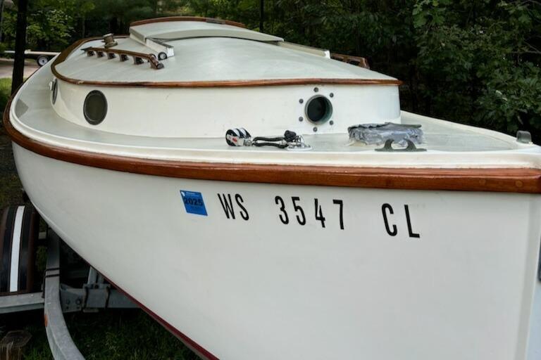 1974 Herreshoff American sailboat on trailer, registration WS 3547 CL, white hull with wood trim.