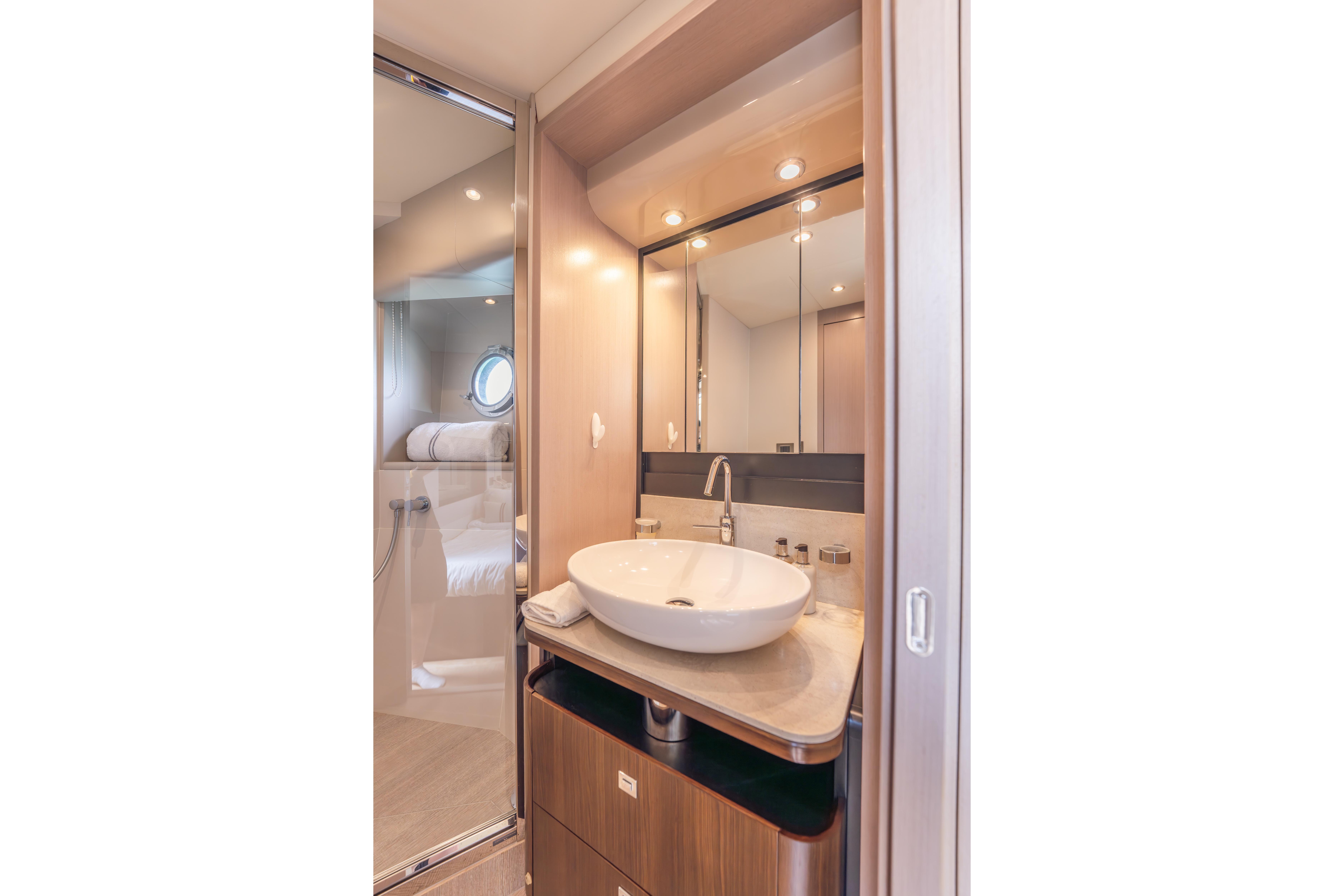 Luxurious bathroom interior of 2019 Absolute 58 FLY yacht with modern sink and mirror.