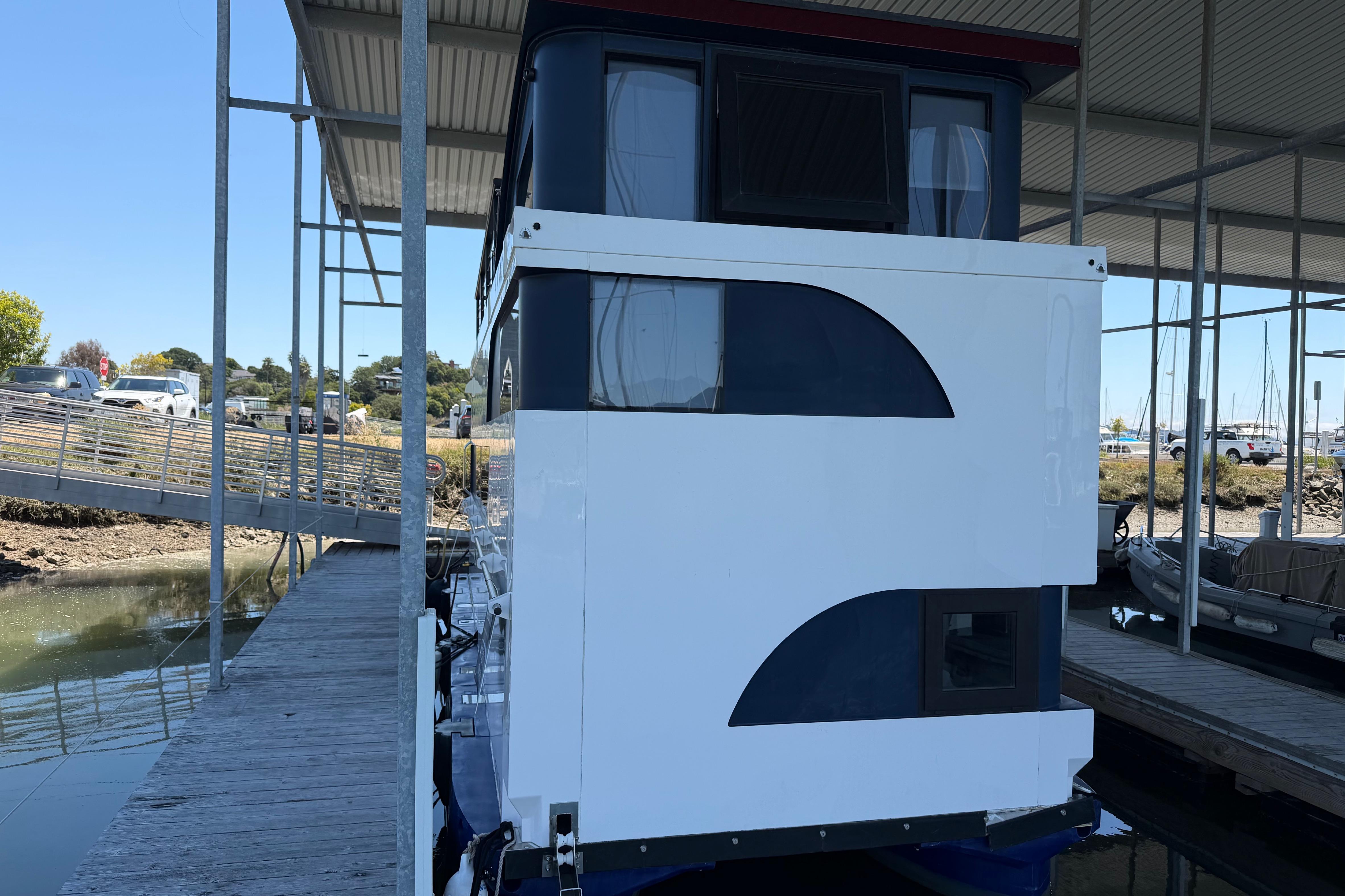 2022 Navisyo NV.08 houseboat docked under a covered marina, showcasing modern design.