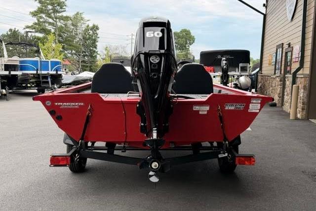 2026 Tracker Pro Team 175 boat, red exterior, parked outdoors, rear view with motor.