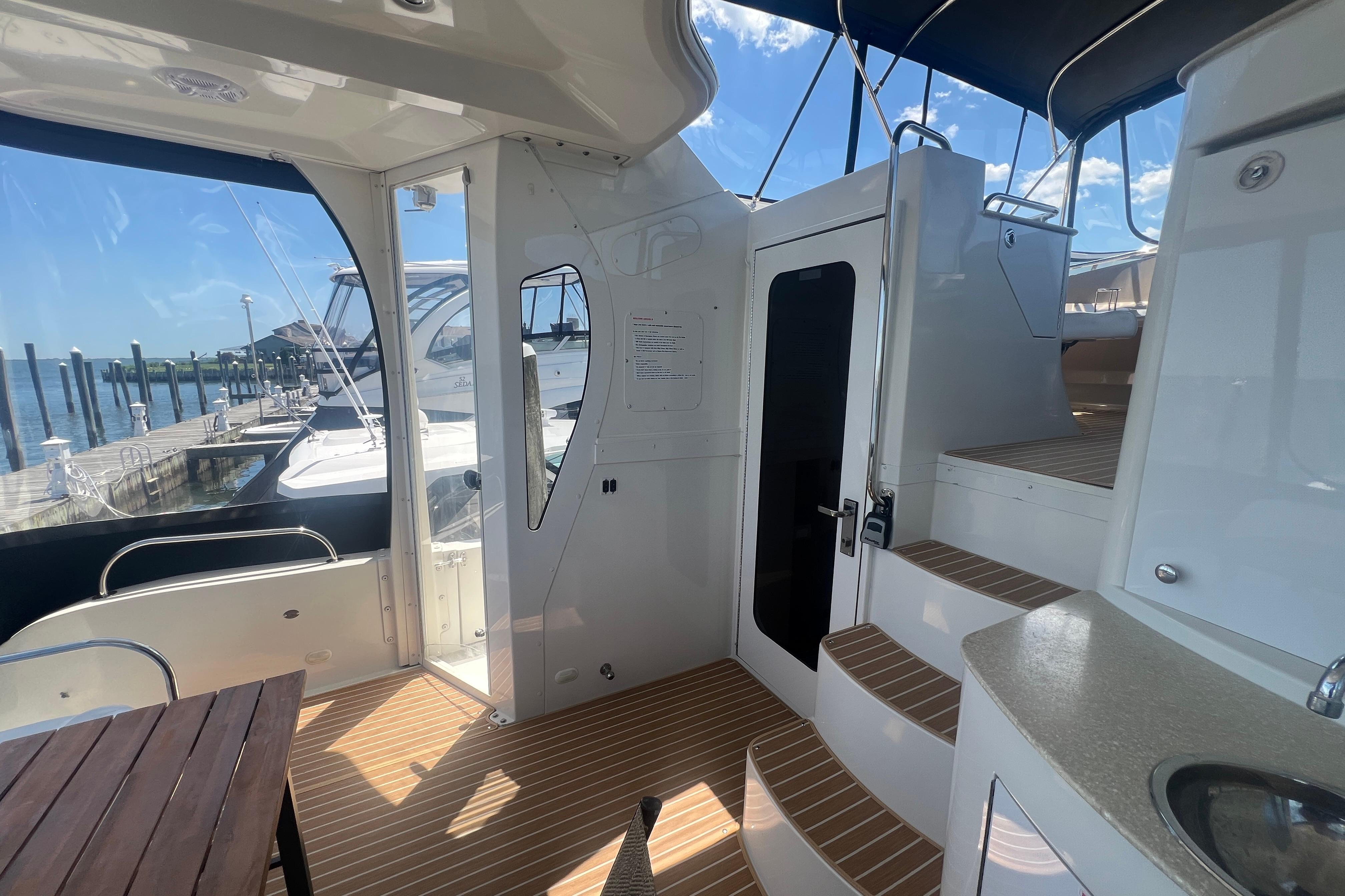 2006 Carver 43 Motor Yacht interior with stairs, wooden flooring, and marina view.