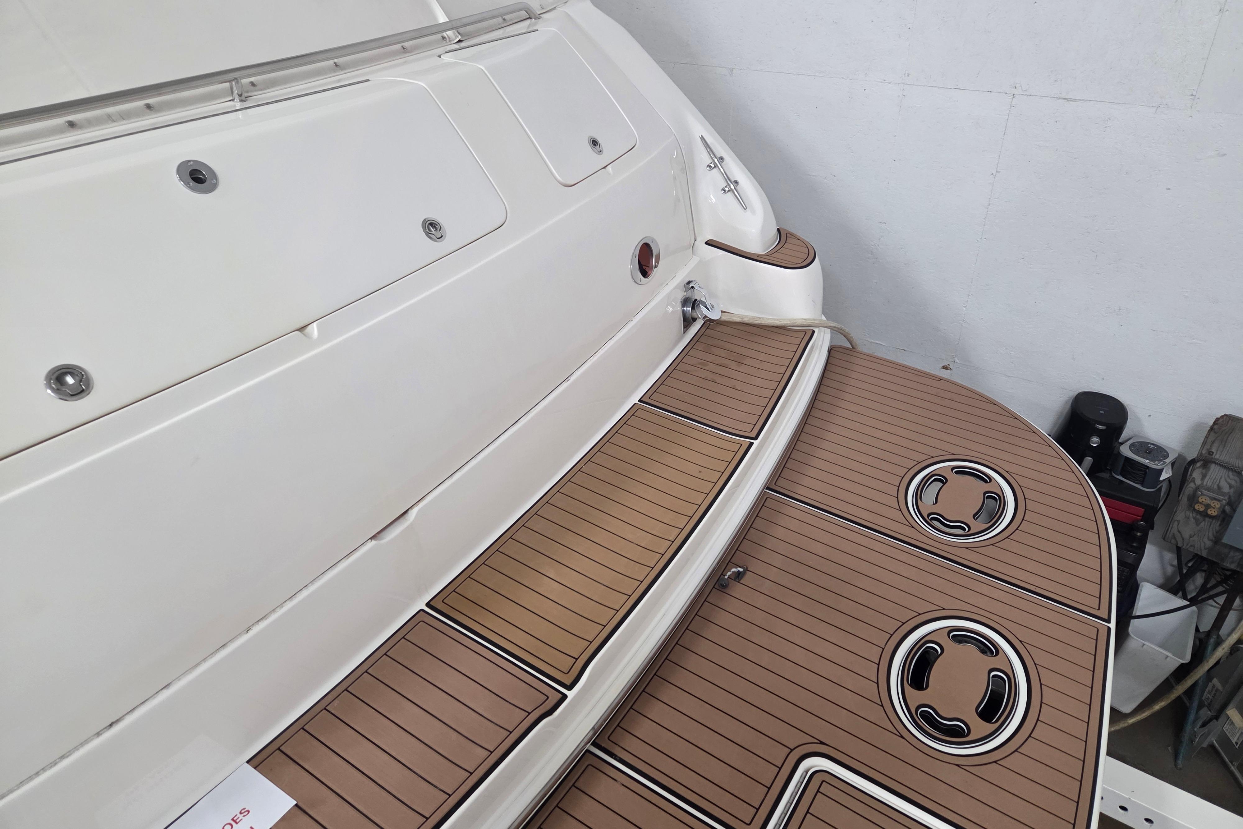 2000 Sea Ray Sundancer 540 swim platform with teak decking in a garage setting.