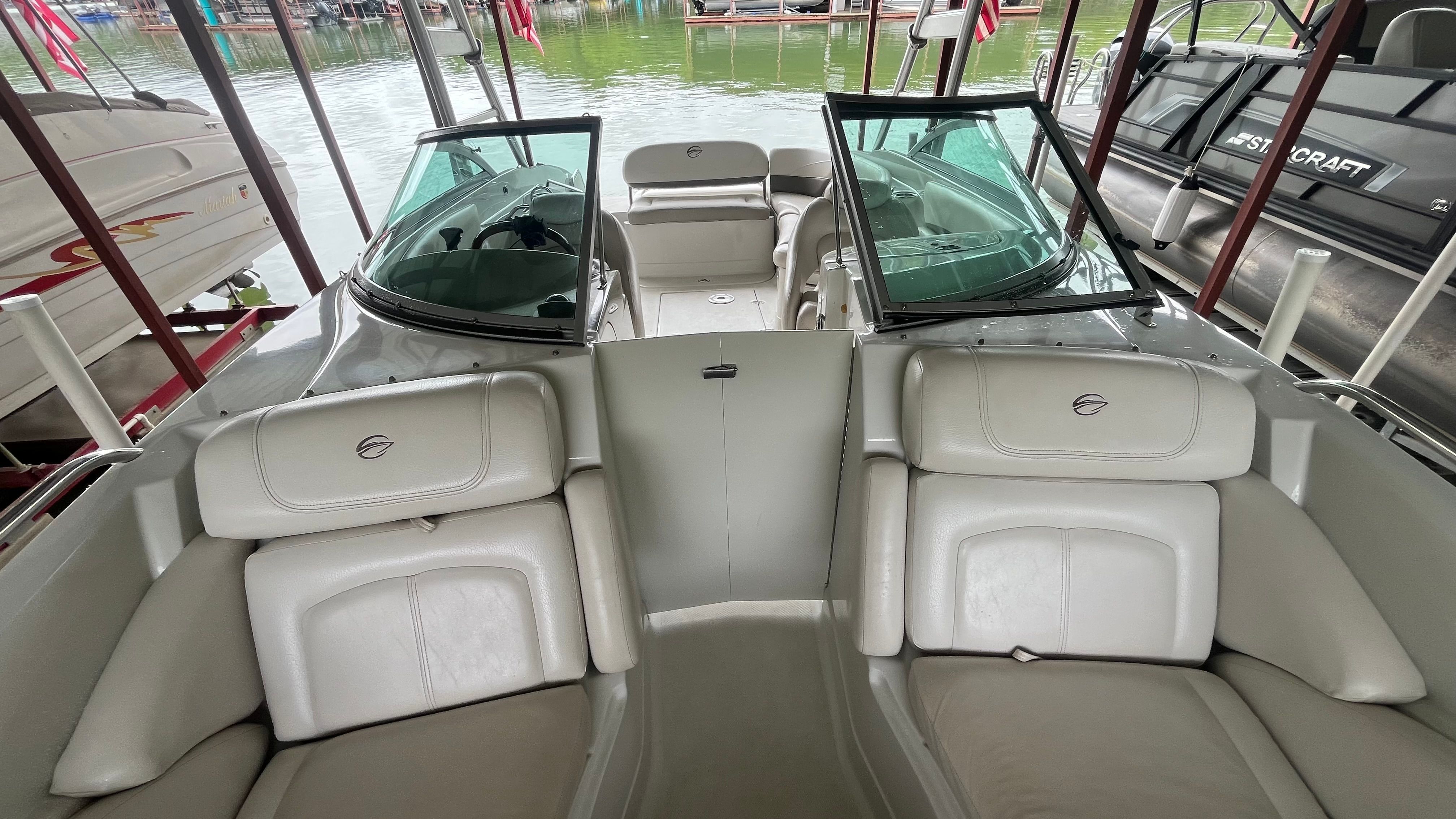 Interior view of a 2008 Crownline 252EX boat with beige seating and open cockpit.