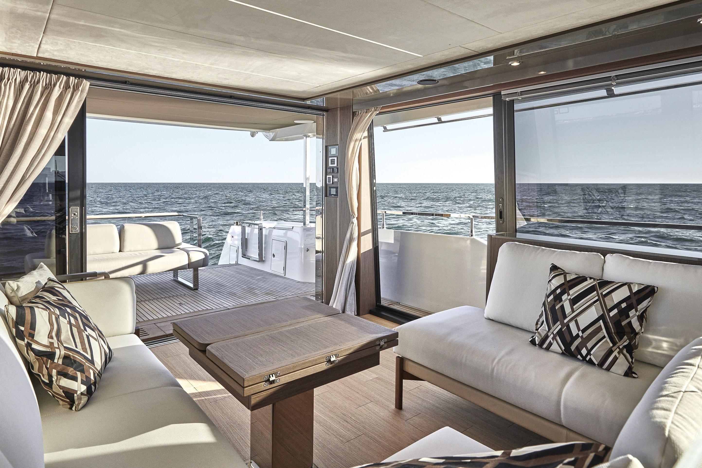 Luxurious interior of 2026 Prestige X60 yacht with ocean view and elegant seating.