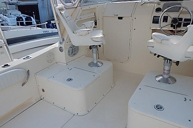 2003 World Cat 270 EC boat interior with helm seats and control panel.