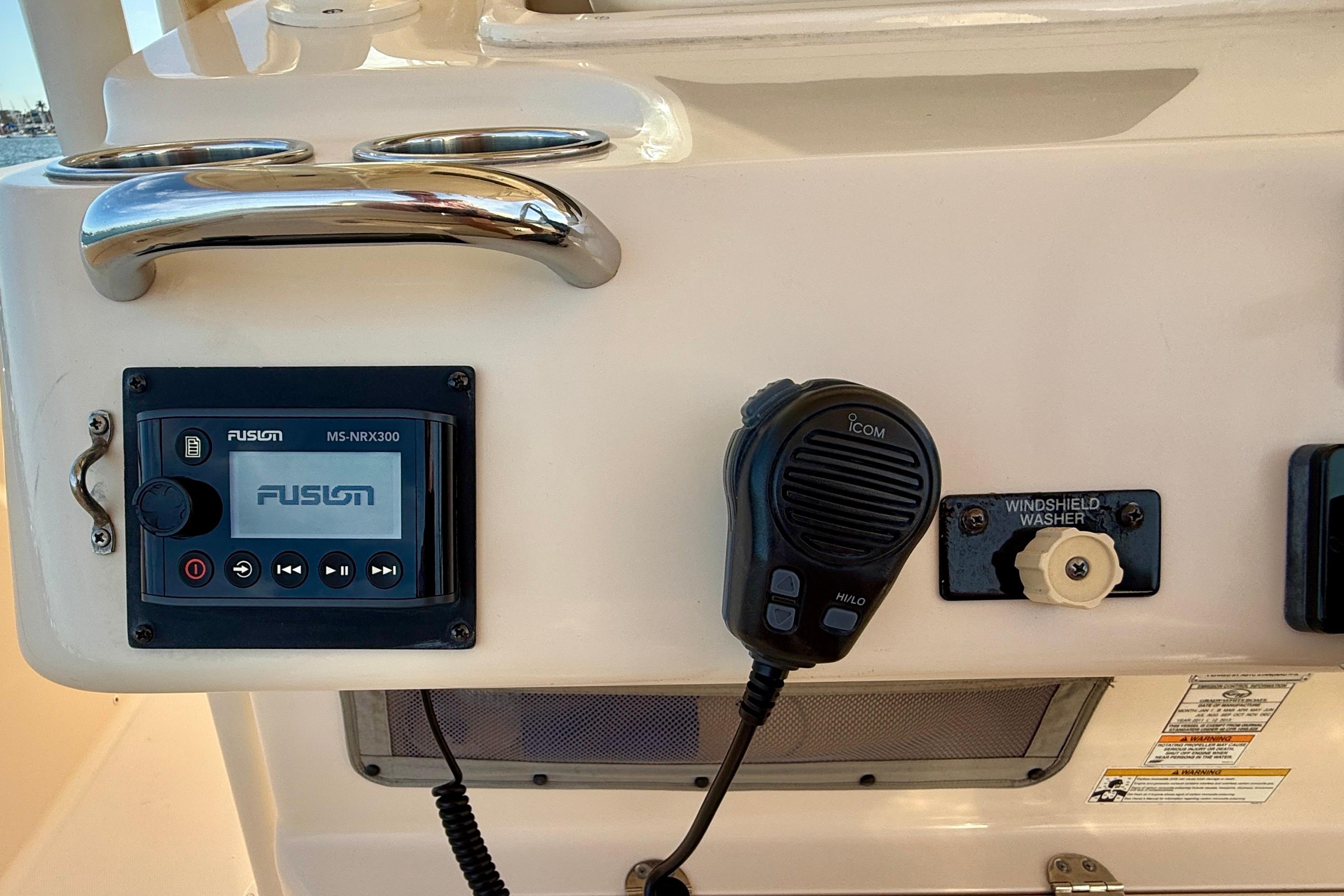 Control panel of a 2012 Grady-White Canyon 336 boat with Fusion stereo and Icom microphone.
