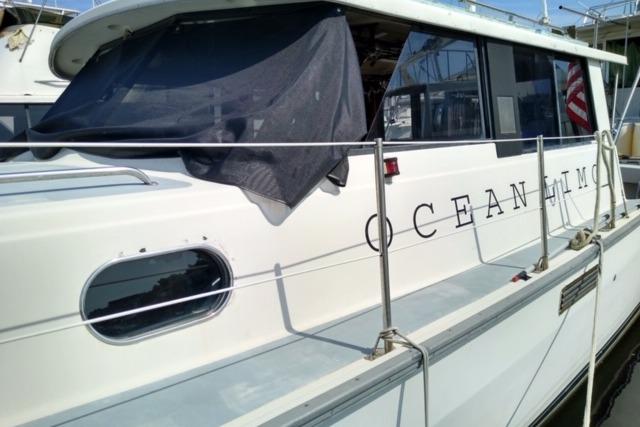 1979 Mainship 34 Custom Sedan docked, featuring "Ocean Limo" lettering on the side.