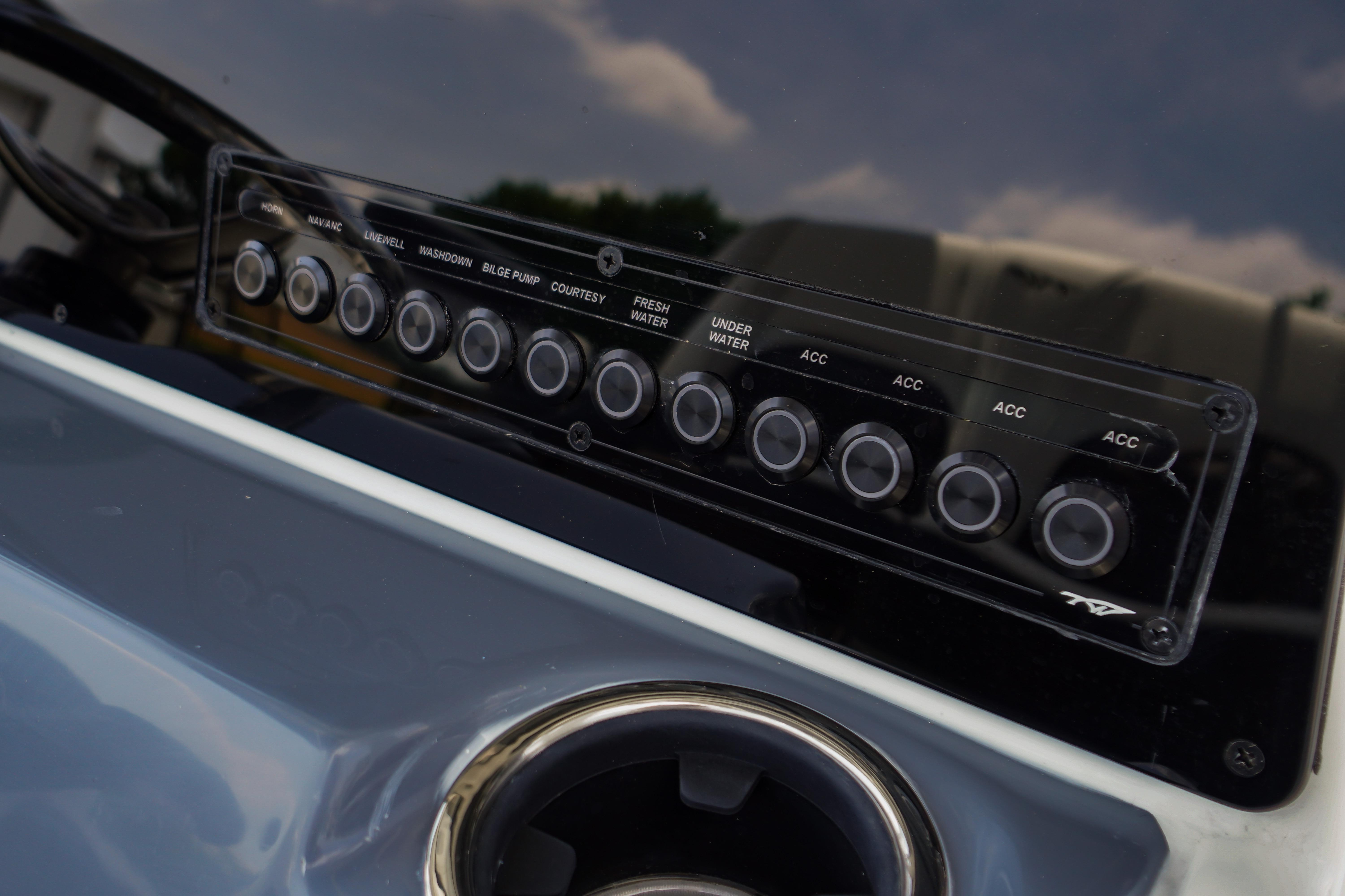 Control panel of 2027 Tidewater 220 CC Adventure boat with labeled buttons.