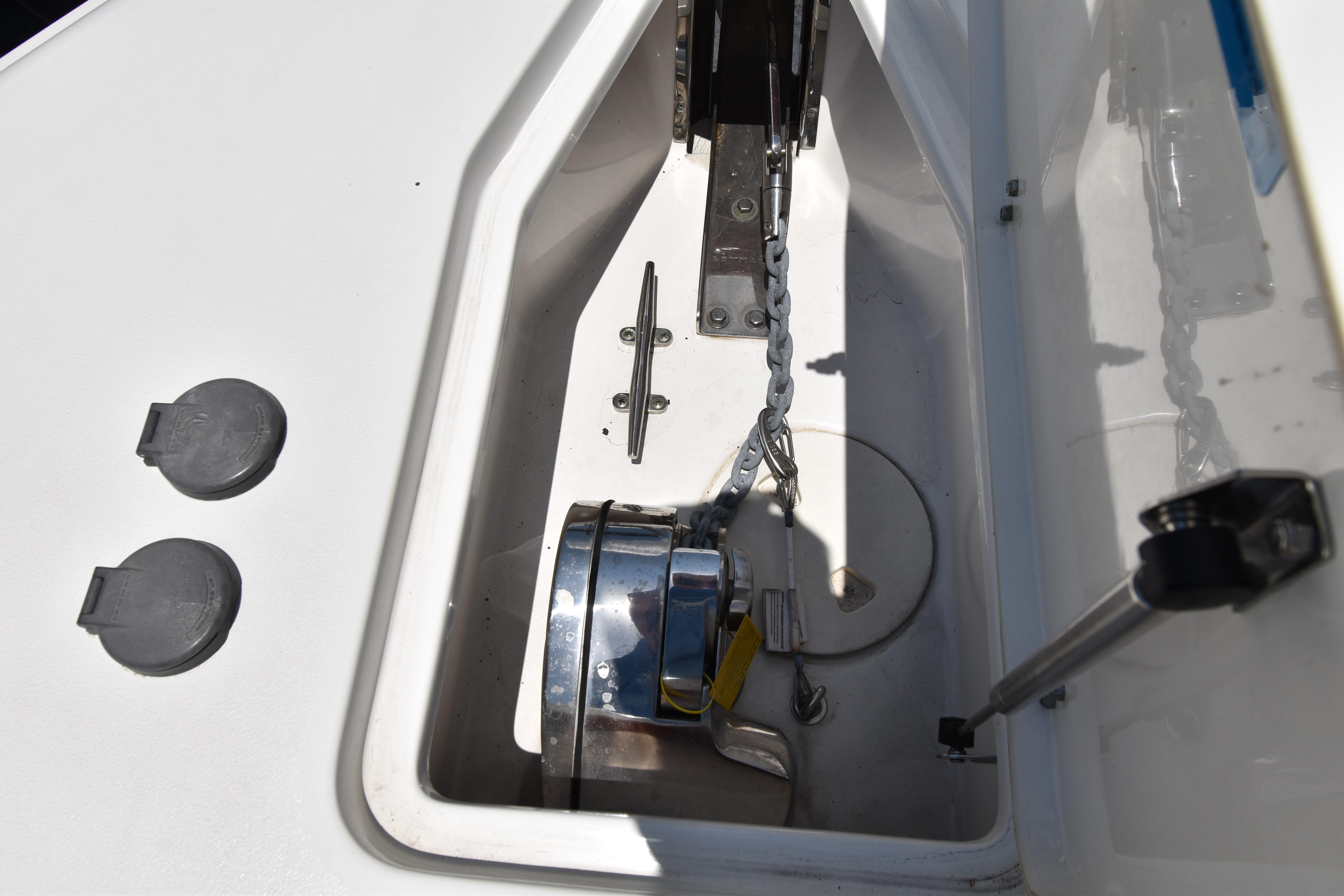 Anchor compartment of 2020 Sea Hunt Ultra 275 SE boat, featuring chain and winch.