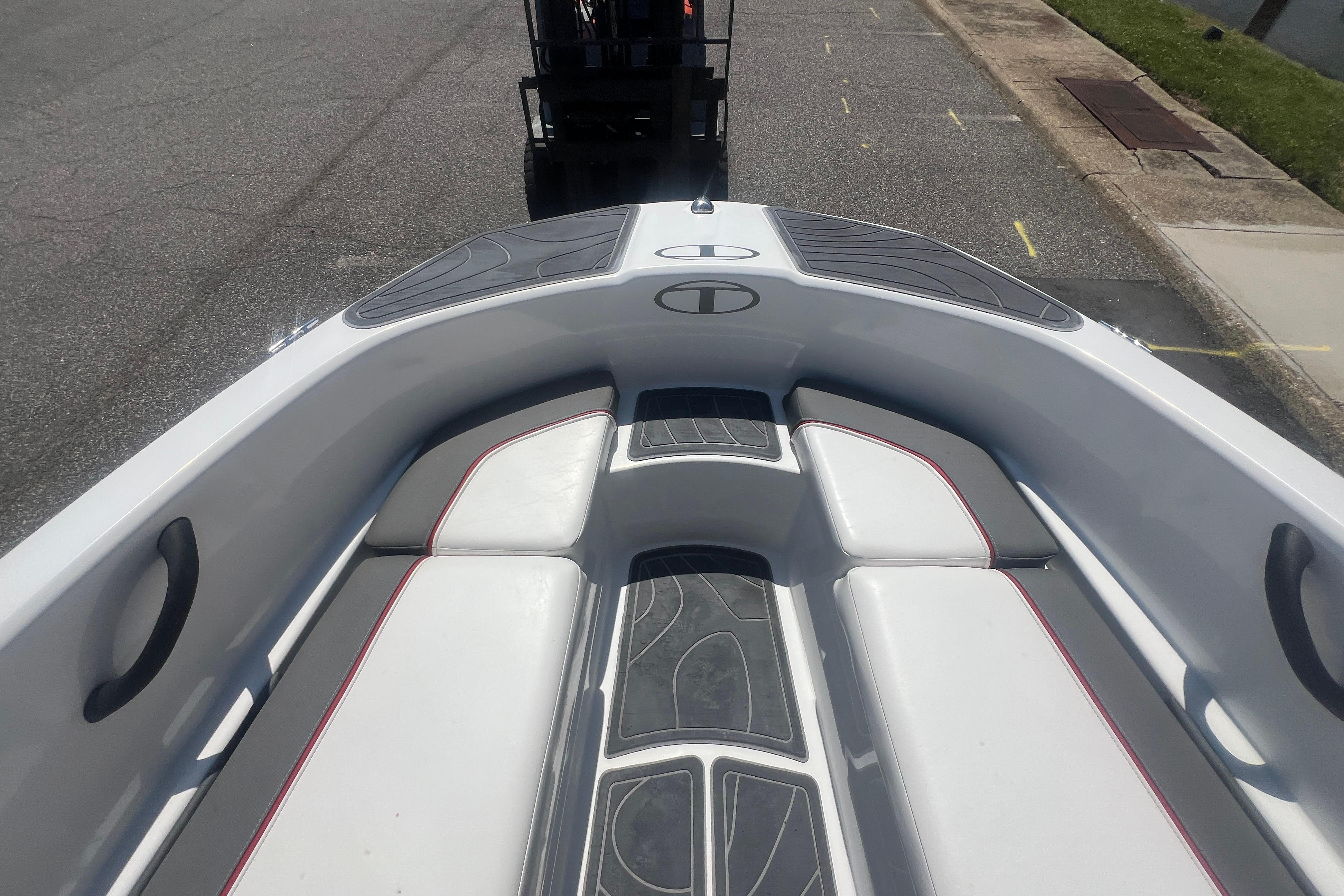 2023 Tahoe T16 boat interior with white seating and gray accents on a street.