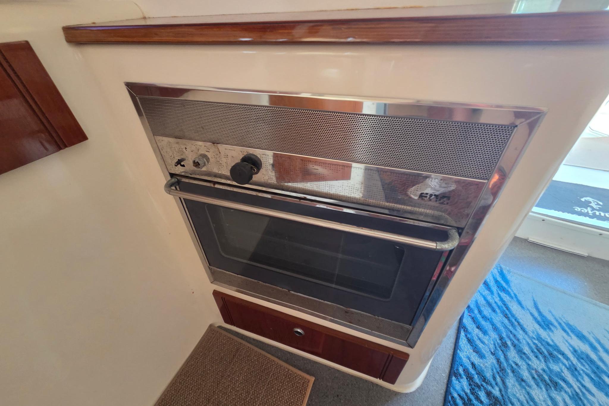 Built-in oven on Fountaine Pajot Greenland 34 yacht, 2000 model, with wooden accents.