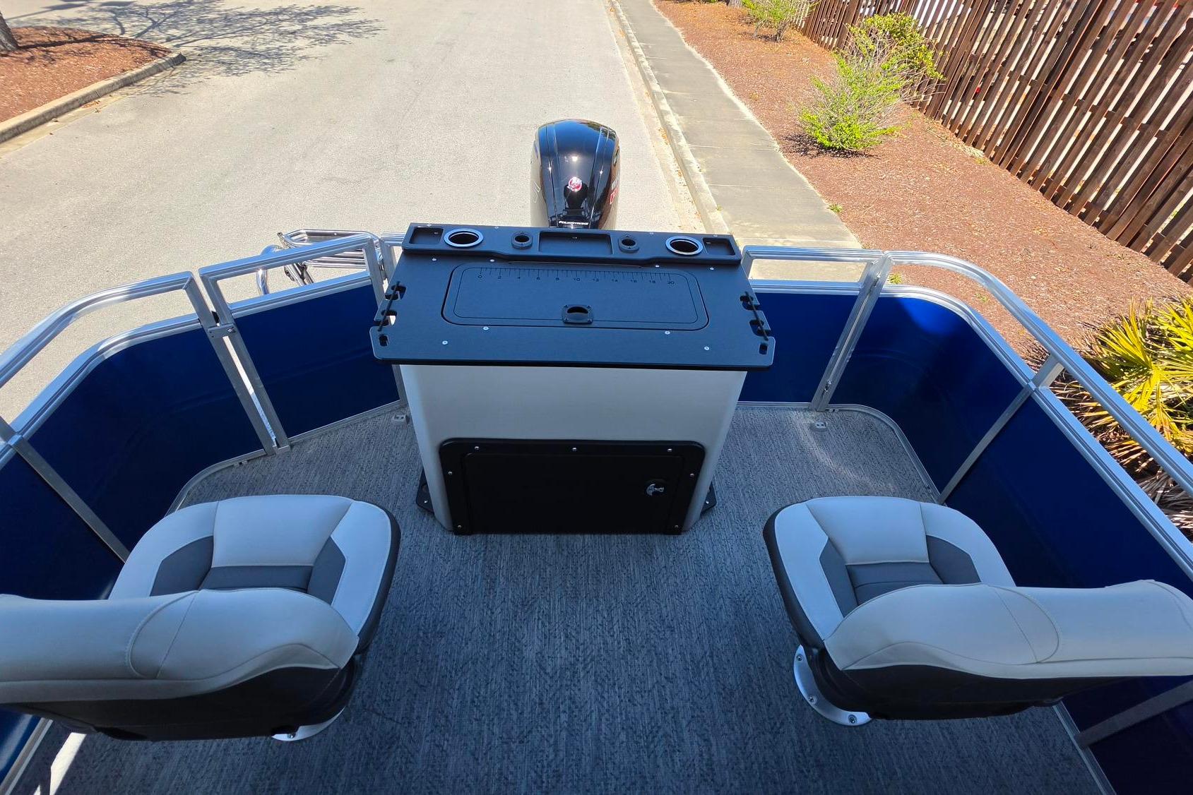 2026 Sun Tracker Fishin' Barge 20 DLX interior with seating and control console.