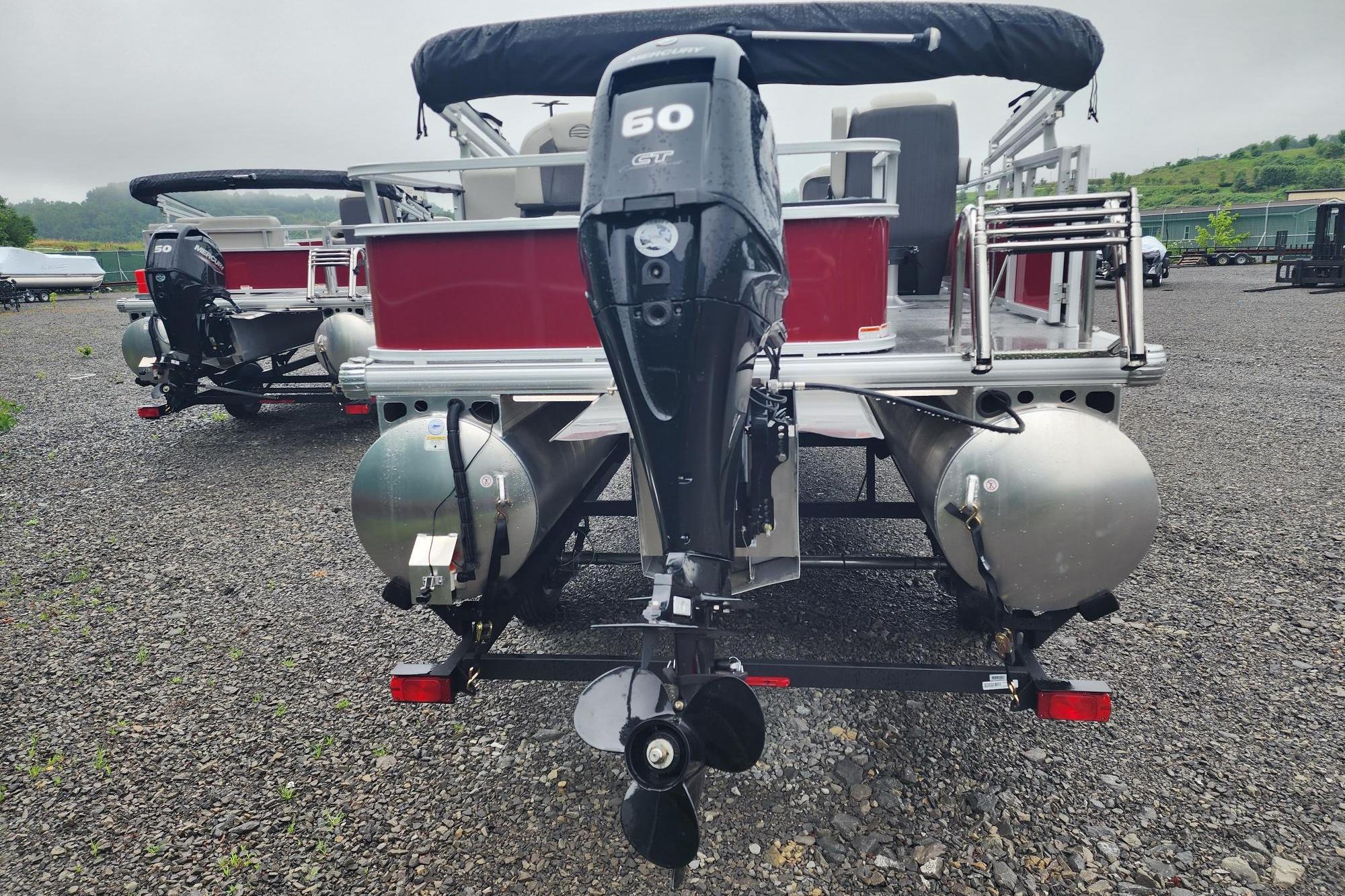 2026 Sun Tracker Bass Buggy 18 DLX pontoon boat with 50 HP engine, rear view.