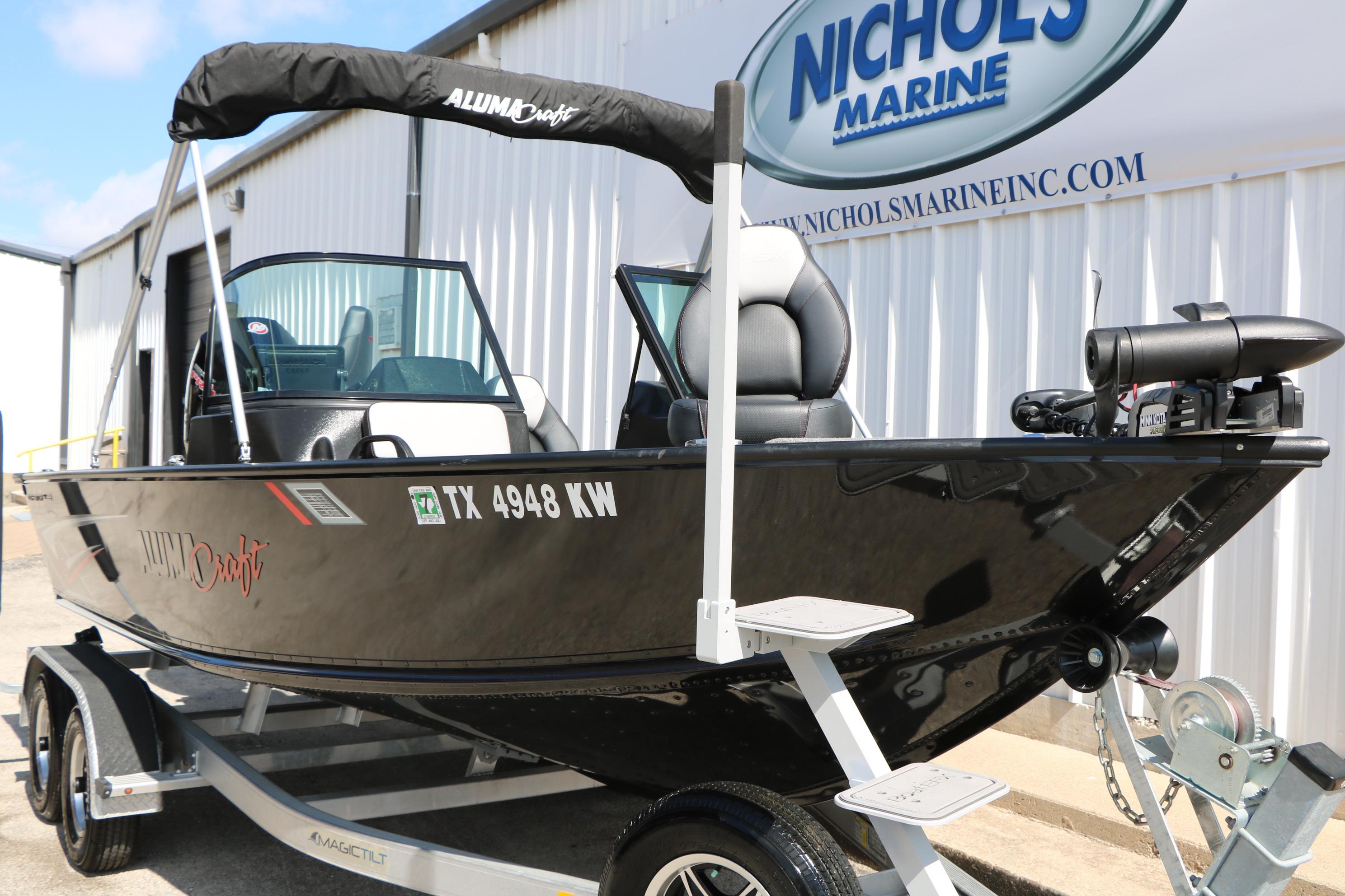 2023 Alumacraft Competitor FSX 185 boat on trailer at Nichols Marine dealership.