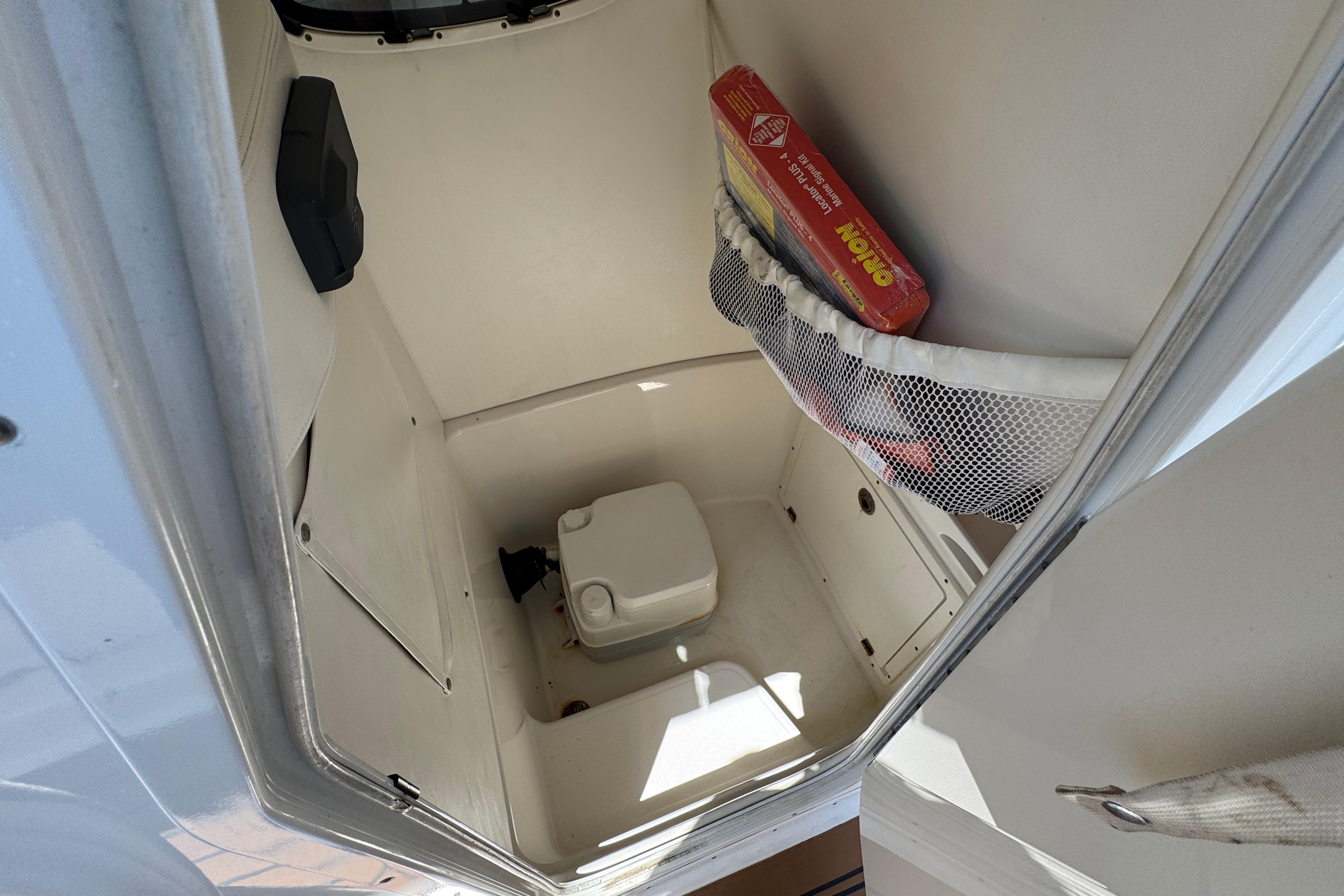 Interior of a 2014 Century 2301 Center Console boat with storage and toilet.