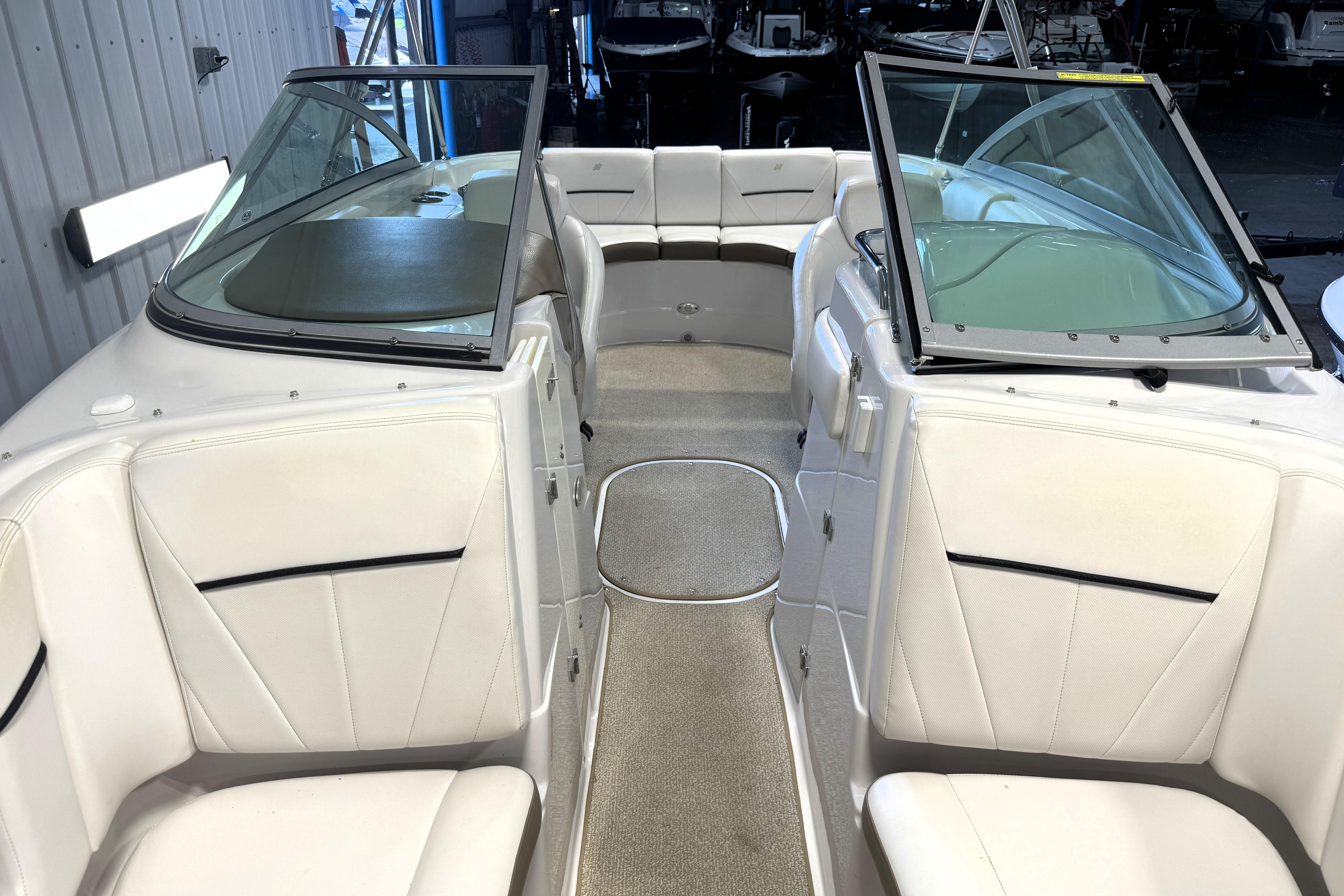 2008 Four Winns H240 boat interior with white seating and open windshield.