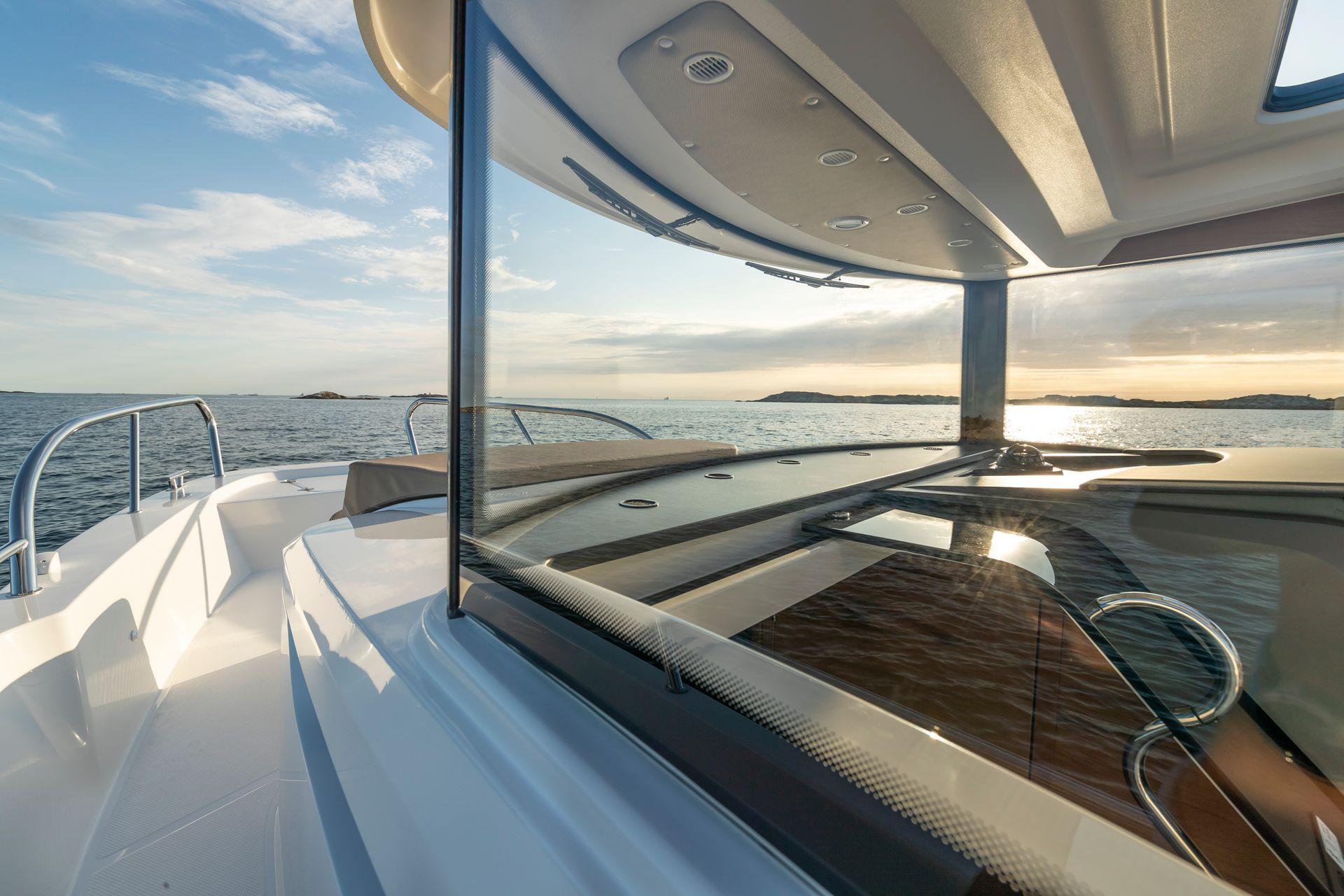 Nimbus C9 boat, 2025 model, cruising on a serene ocean at sunset.