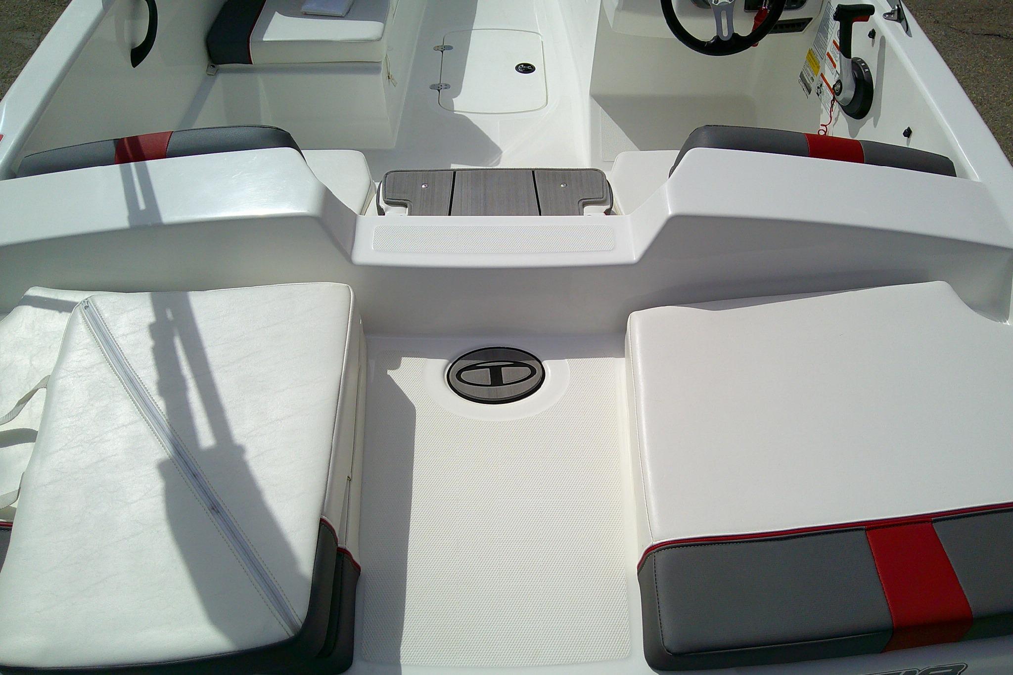 2024 Tahoe T18 boat interior with white and gray seating, red accents, and steering wheel.
