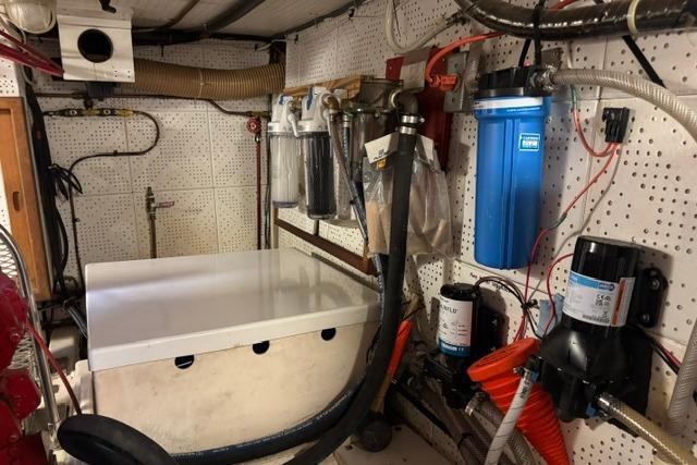 Engine room of a 1986 Kadey-Krogen 42 yacht, featuring various mechanical components and filters.