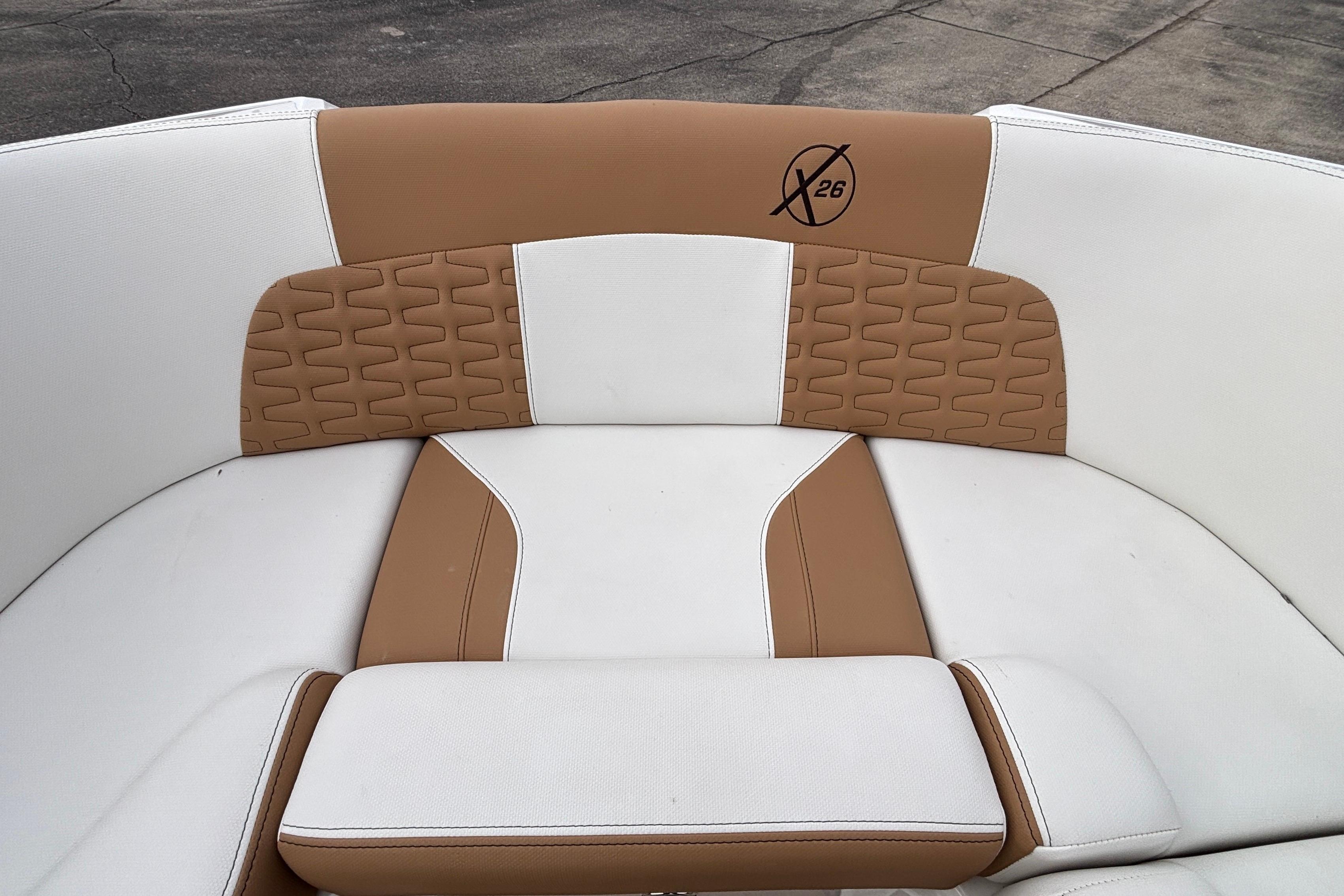 2022 MasterCraft X26 boat interior with tan and white cushioned seating.