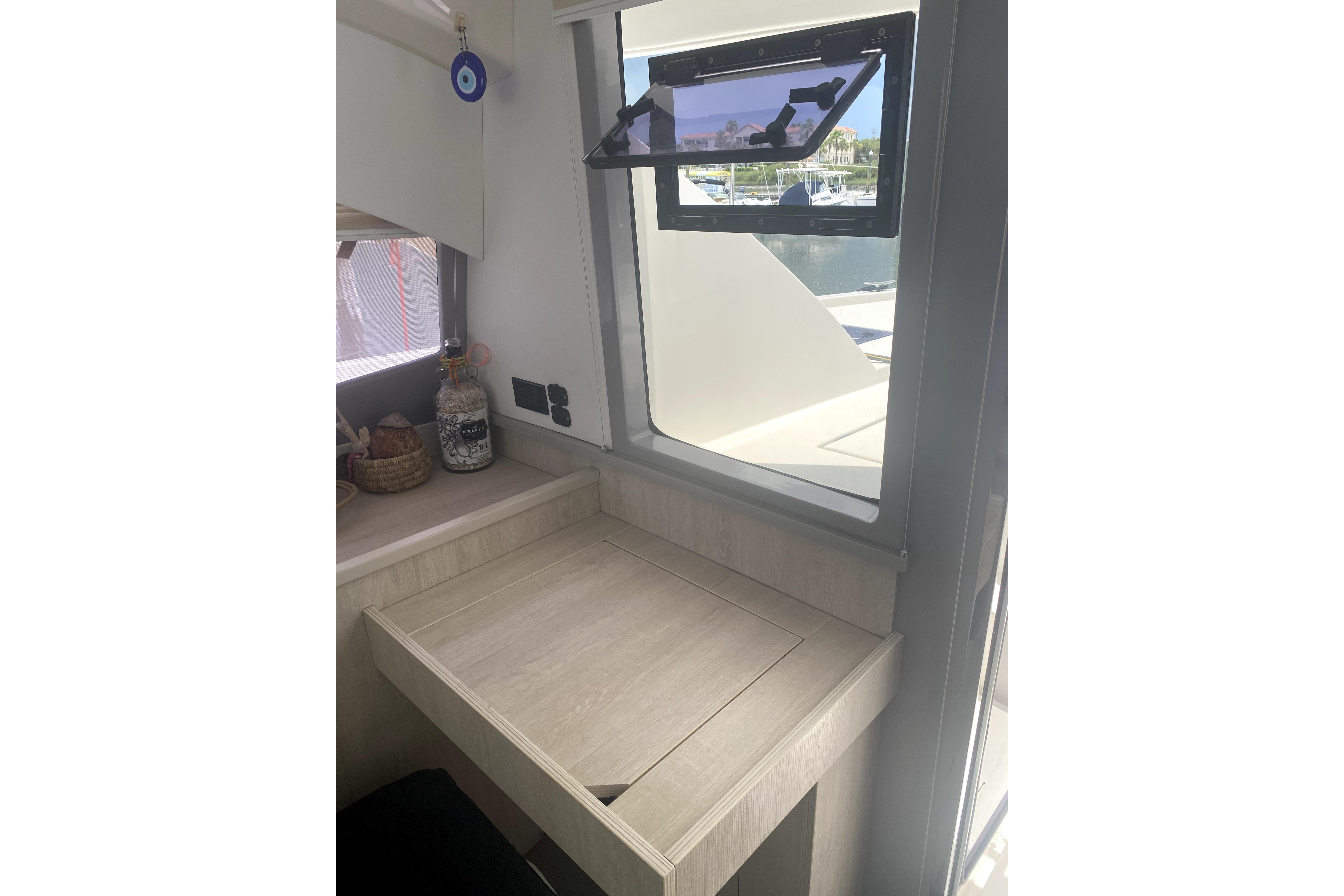 Interior of 2017 Leopard 40 catamaran with desk and open window view.