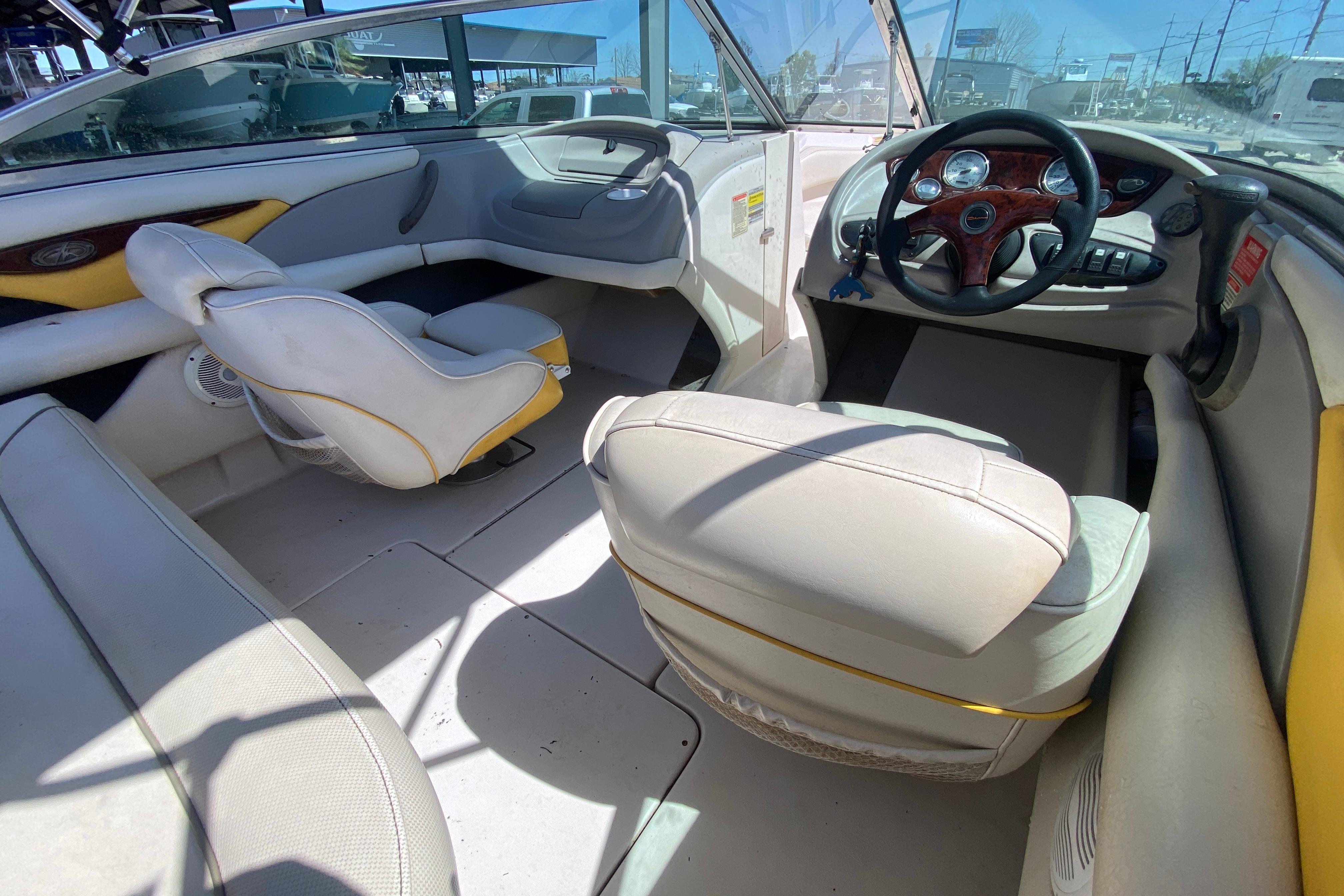 Interior of a 2003 Monterey 208SI Montura boat, featuring seating and steering wheel.