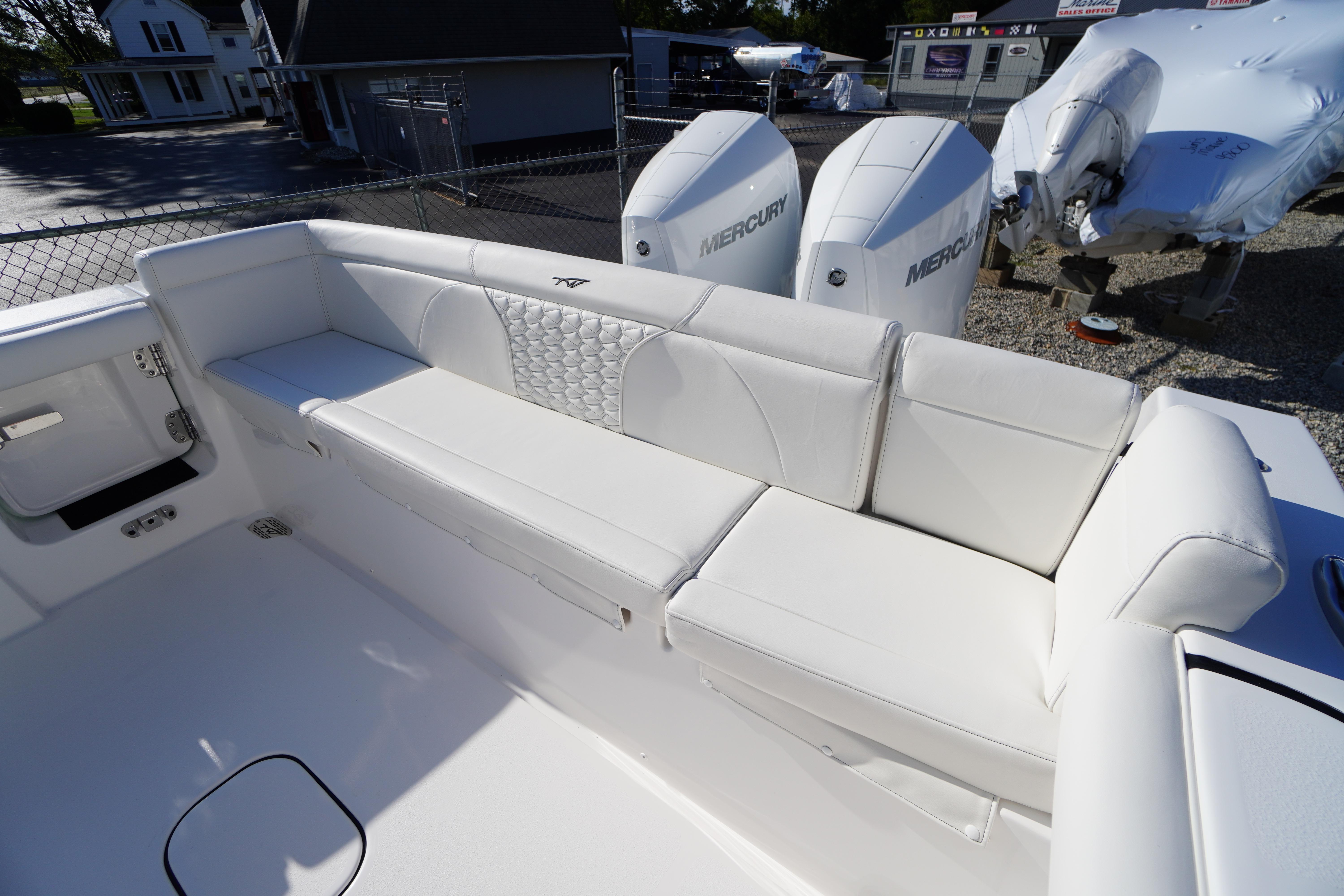 2026 Tidewater 272 LXF boat with white seating and dual Mercury engines.