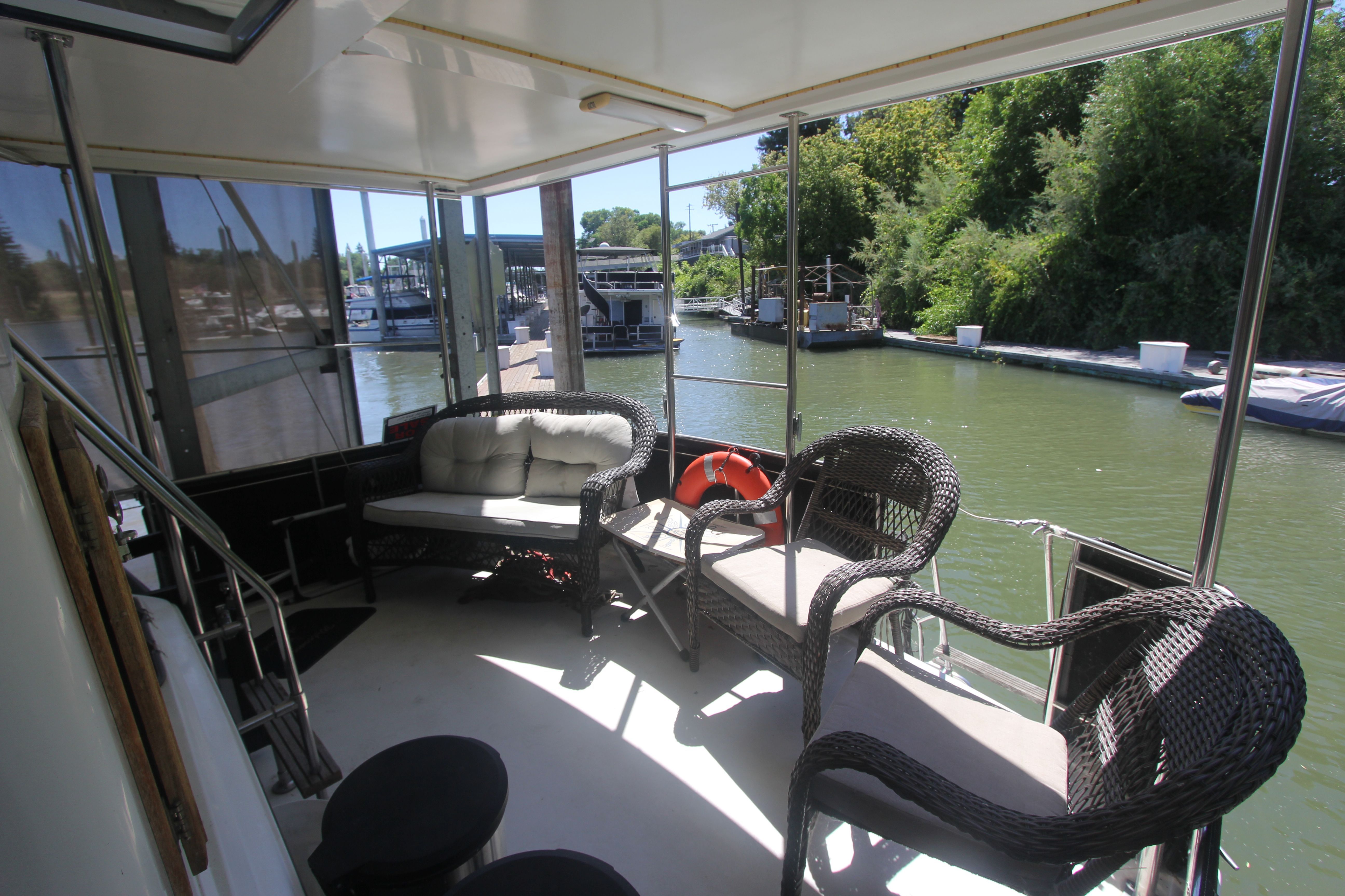 The image shows the aft deck of a 1988 Carver 3607 Aft Cabin Motor Yacht with seating.