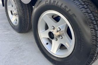 2007 Cobalt 232 trailer wheels with Carlisle tires on concrete surface.