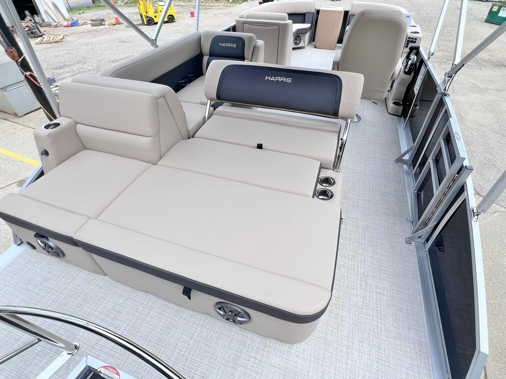 2025 Harris Cruiser 230 pontoon boat interior with beige seating and cup holders.