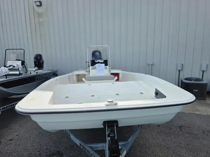 2026 Mako Pro Skiff 17 CC on trailer outside building.
