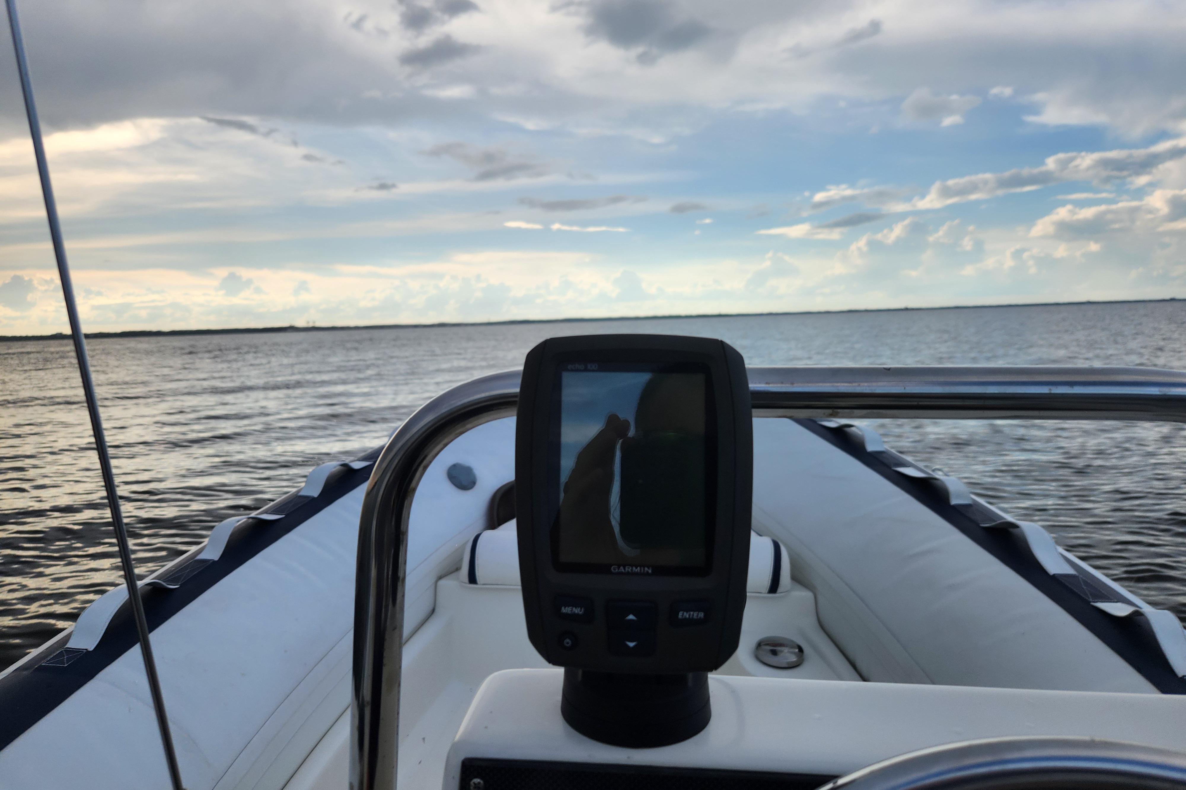 Novurania DL 400 boat with Garmin device, cruising on calm waters under a cloudy sky.