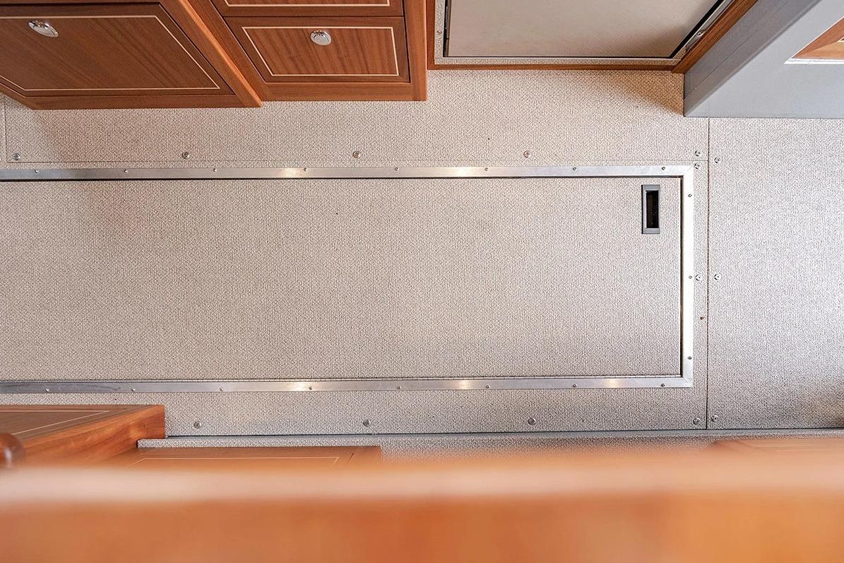 Interior view of 2026 KingFisher 3225 GFX Offshore boat, featuring sleek cabinetry and flooring.
