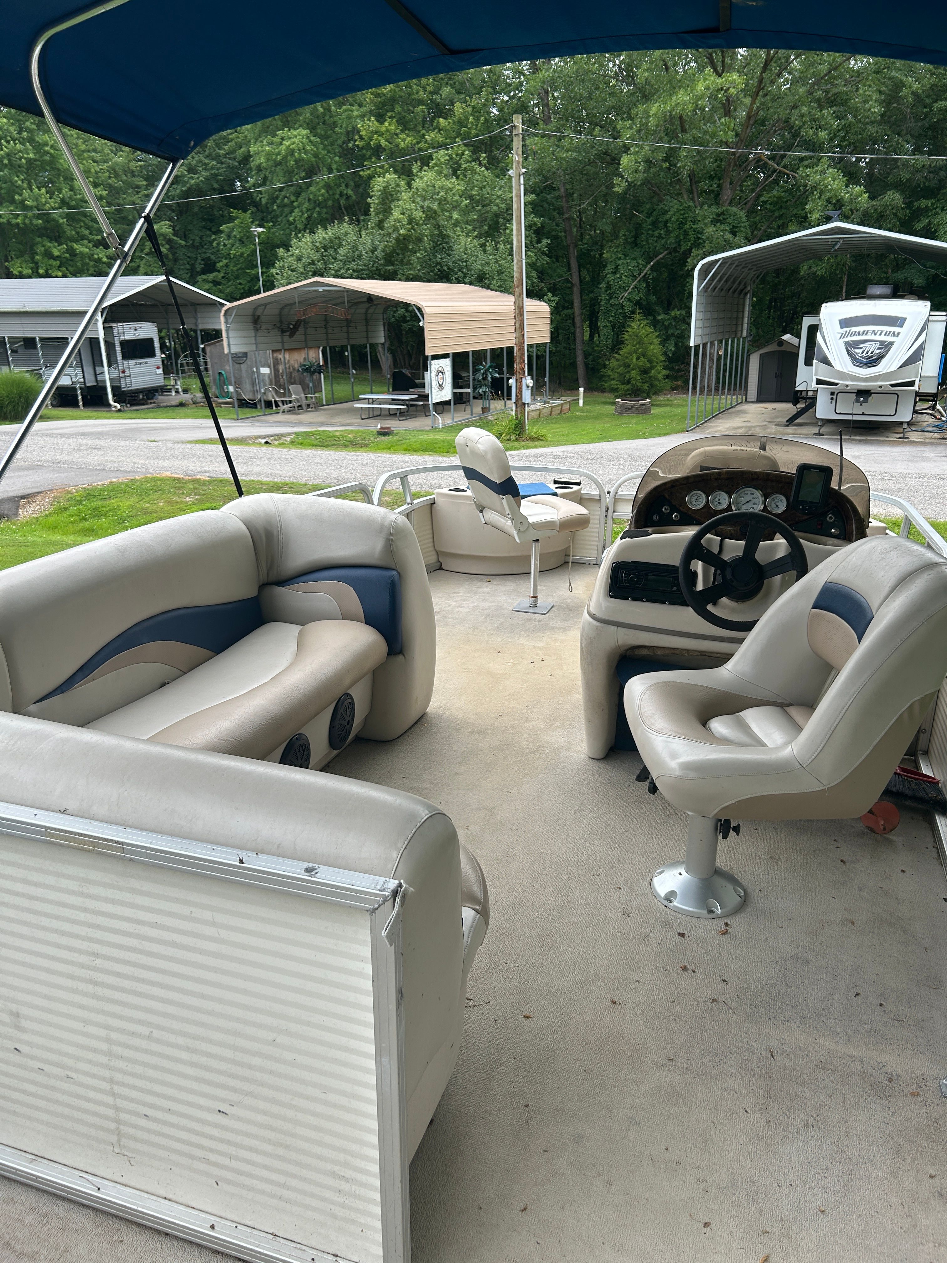 Interior view of a 2008 Sun Tracker Fishin' Barge 21' with seating and helm.