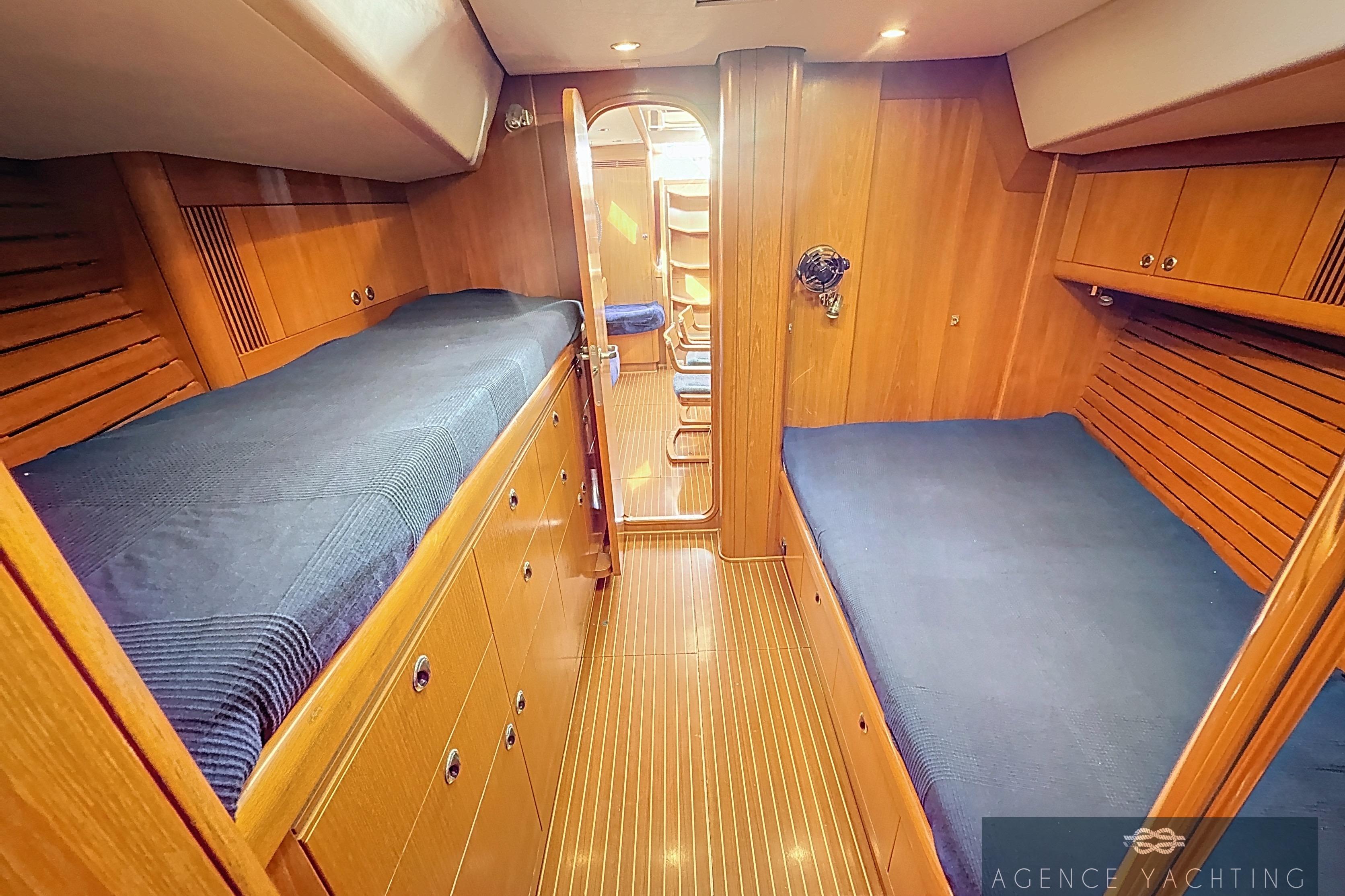 Luxurious wooden cabin interior of 2003 Nautor Swan 48 yacht with twin beds.