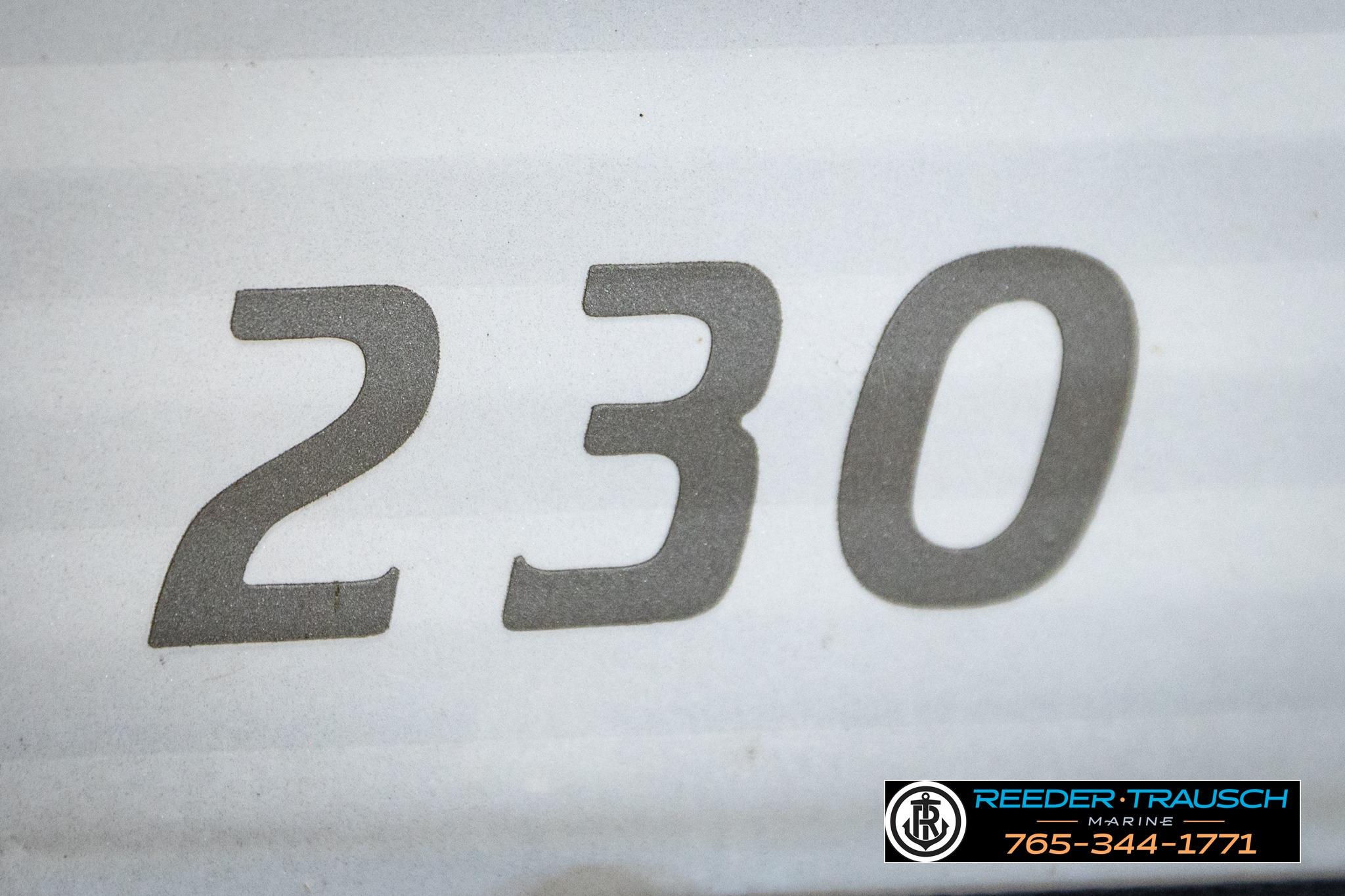 Close-up of '230' on 2019 Manitou Oasis SR VP boat, Reeder-Trausch Marine logo visible.