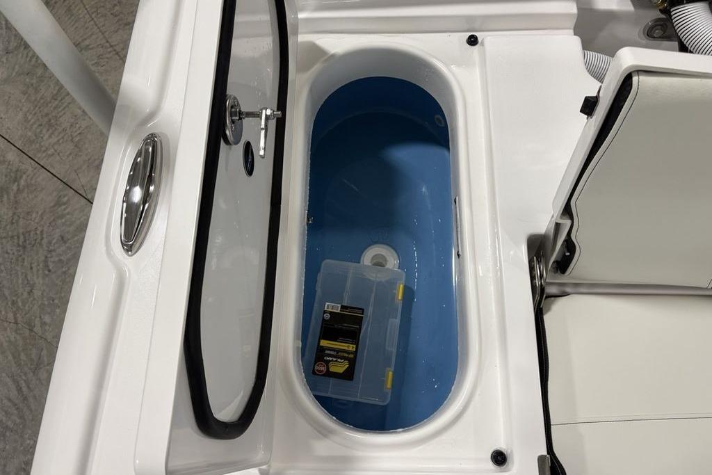 Livewell compartment in 2026 Tidewater 2210 Carolina Bay boat, featuring a blue interior.