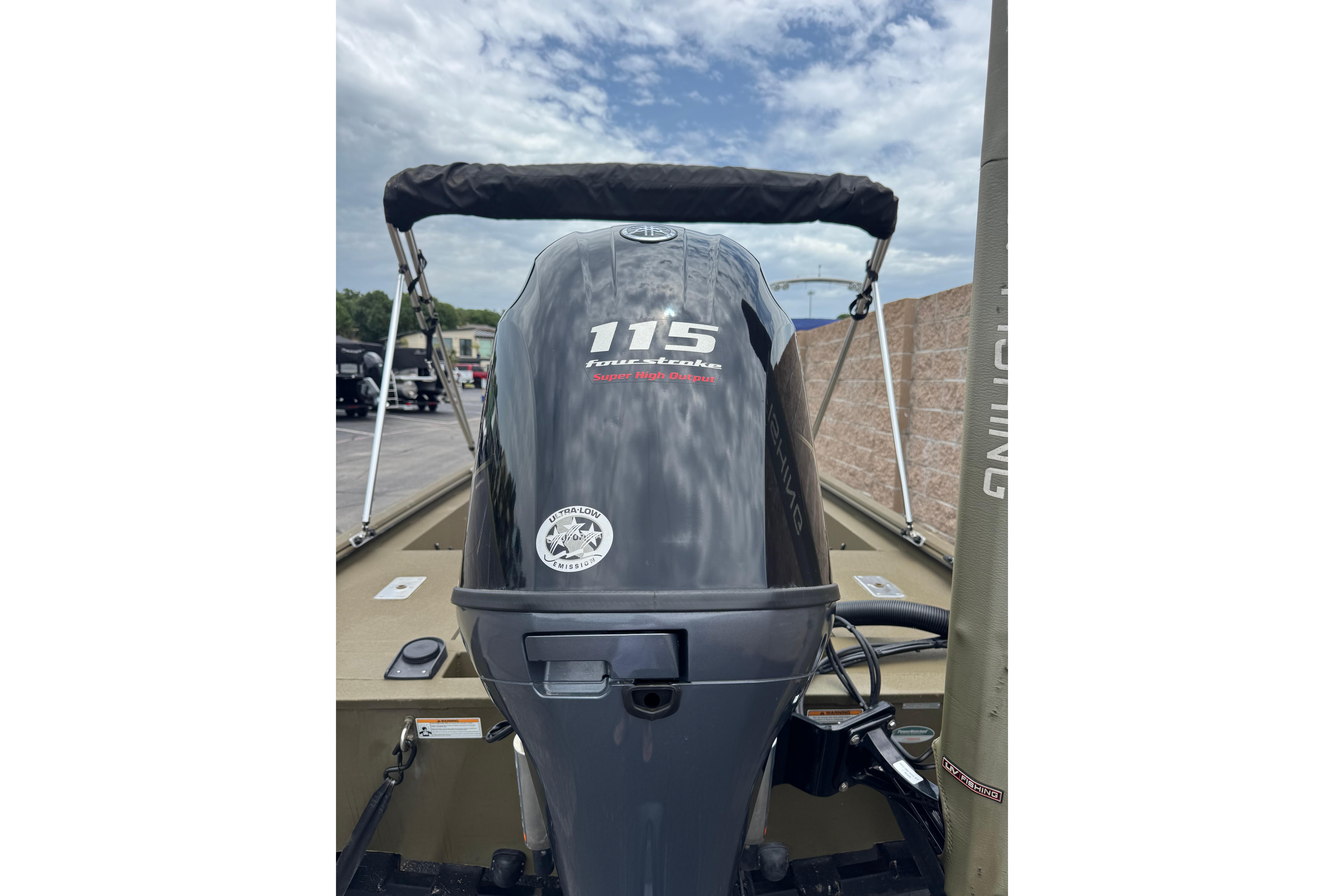 2023 Avid 18 Rogue CC boat with 115 horsepower outboard motor, parked outdoors.