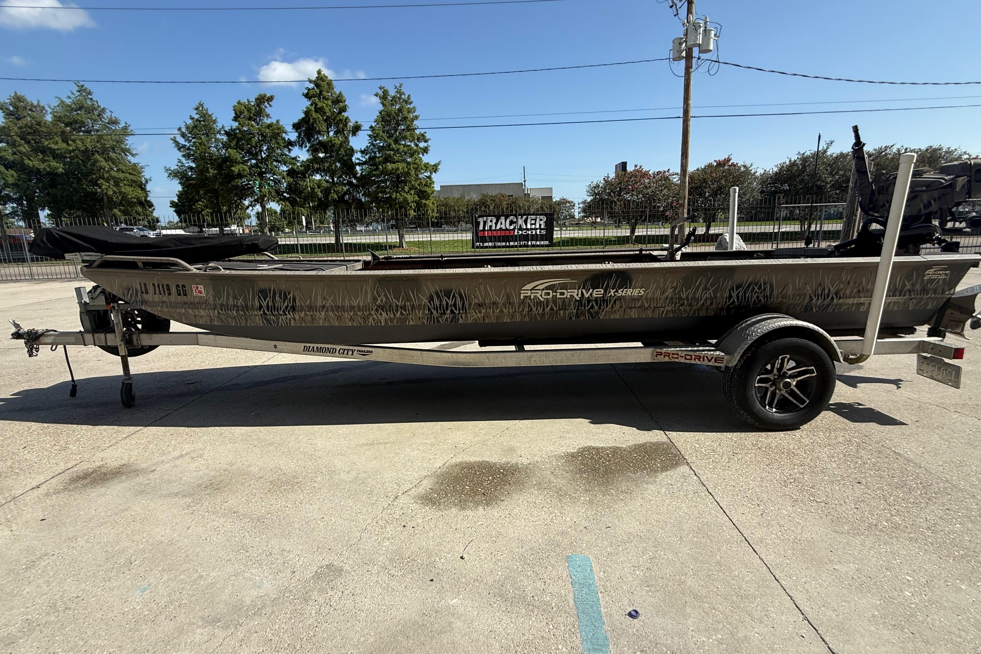 2017 Pro-Drive 2048 boat on trailer, parked outdoors under clear sky.