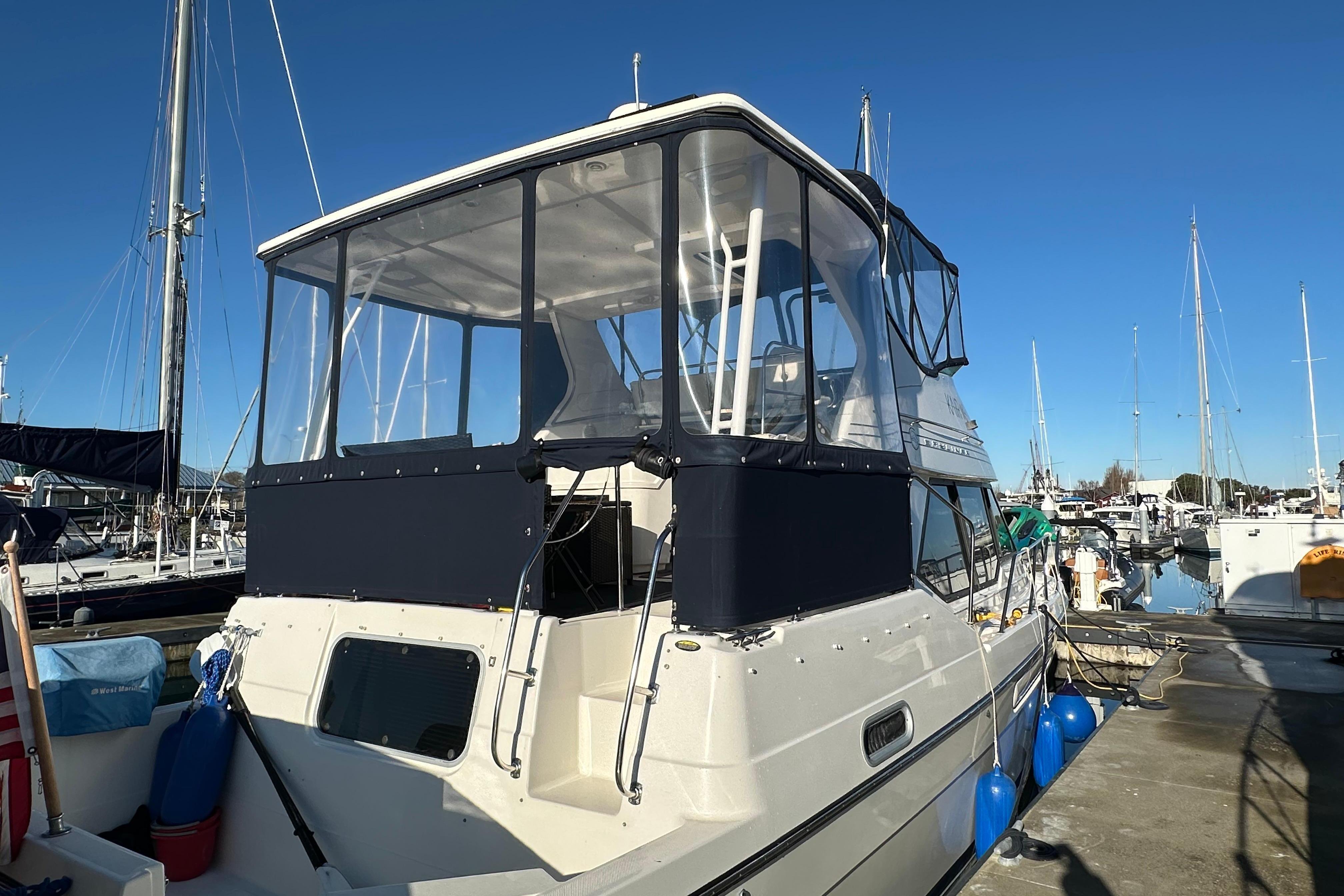 2000 Bayliner 4087 Aft Cabin Motoryacht docked at marina under clear blue sky.