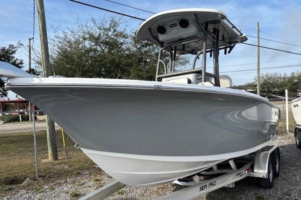 2025 Sea Pro 225FLX Sandbar boat on trailer, parked outdoors.
