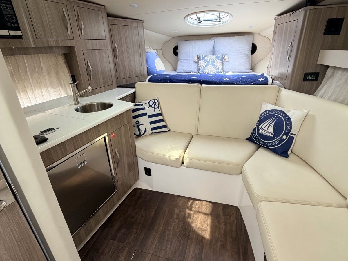Interior of the 2021 Regal 33 Express with cozy seating area and bed.