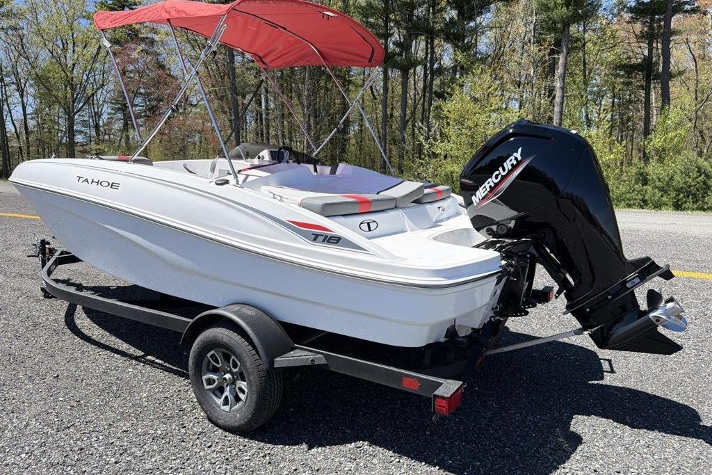2026 Tahoe T18 boat with red canopy and Mercury engine on trailer.