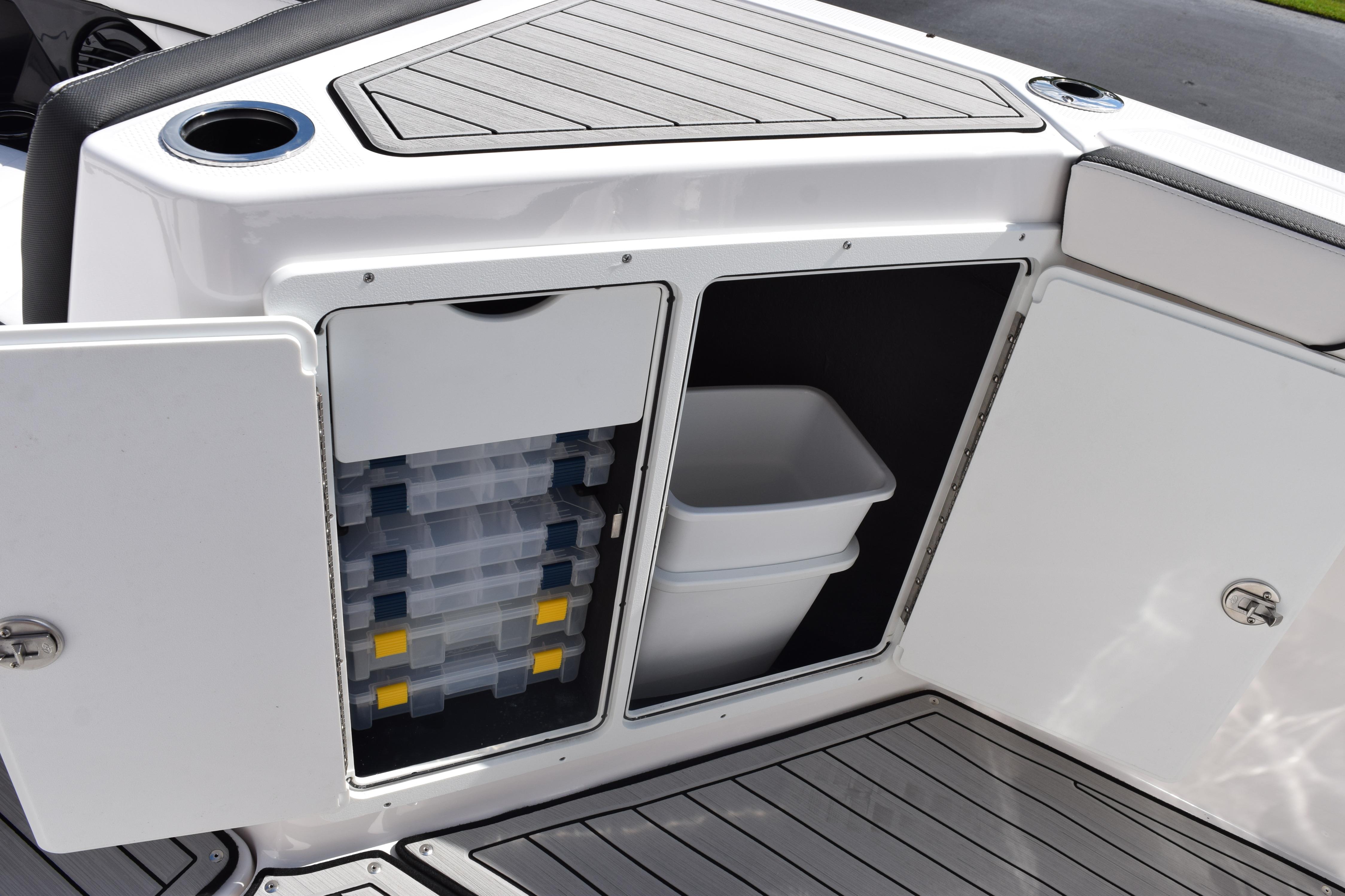 2026 Yamaha Boats 255 FSH Sport H storage compartments with tackle boxes and bin.
